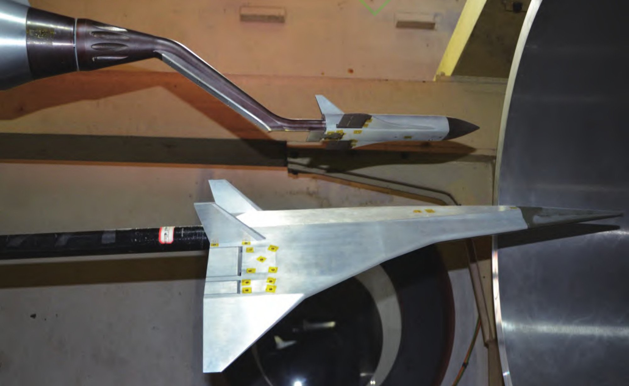 Chinese scientists developed a device that uses robotic arms to hold and tilt prototype planes and their cargo during wind tunnel tests. Credit: Lin Jinzhou