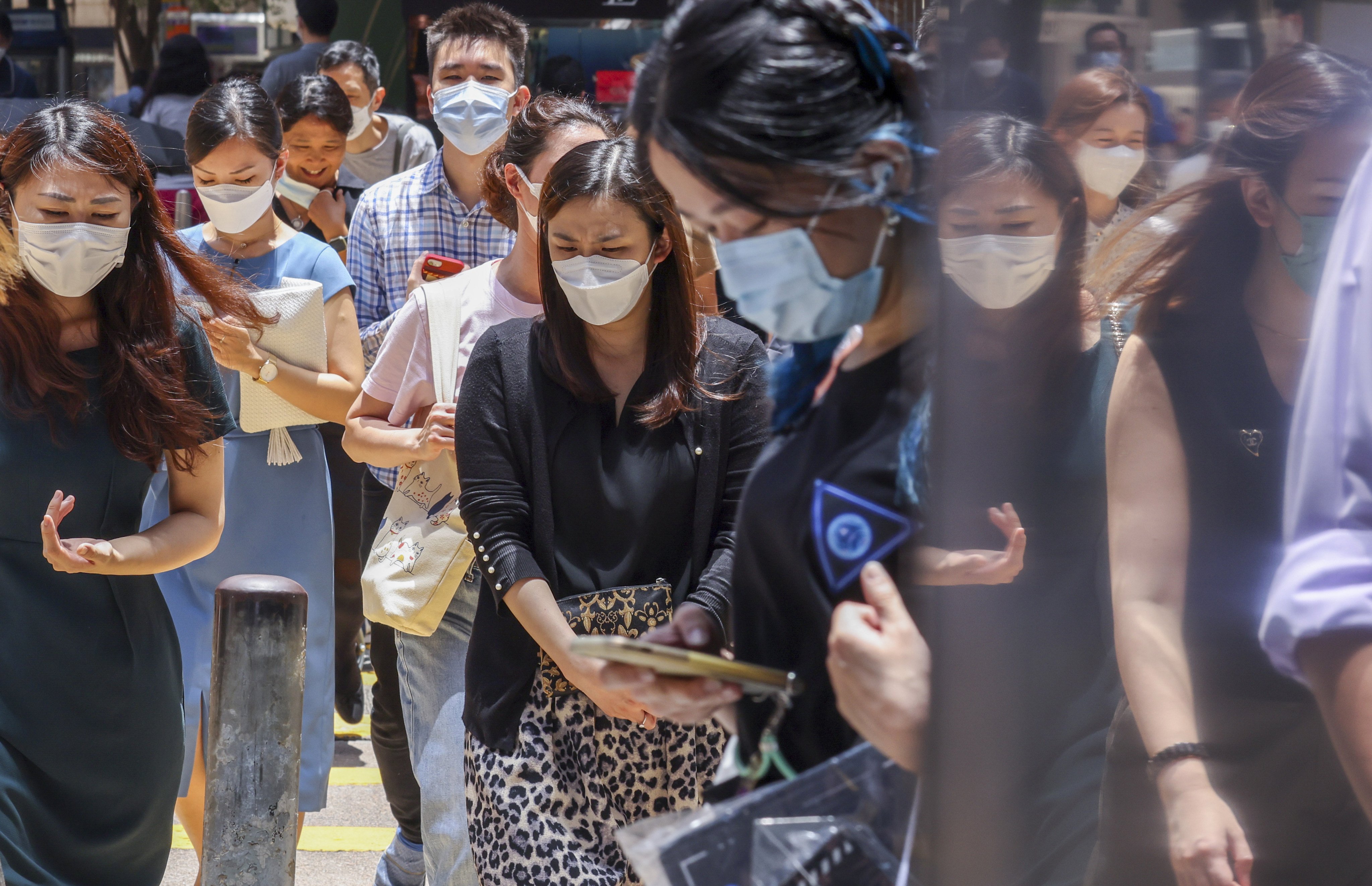 Hongkongers masked up in Central. The city has weathered the worst of a fifth Covid-19 wave. Photo: Nora Tam