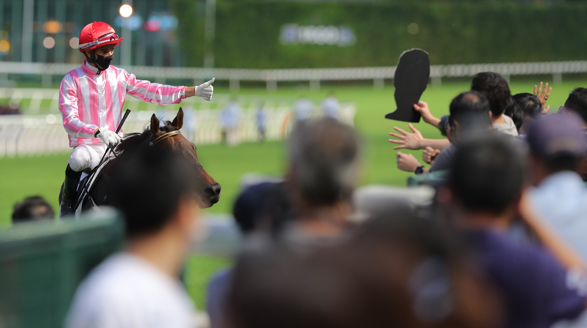 Joao Moreira salutes the Happy Valley crowd after a winner.