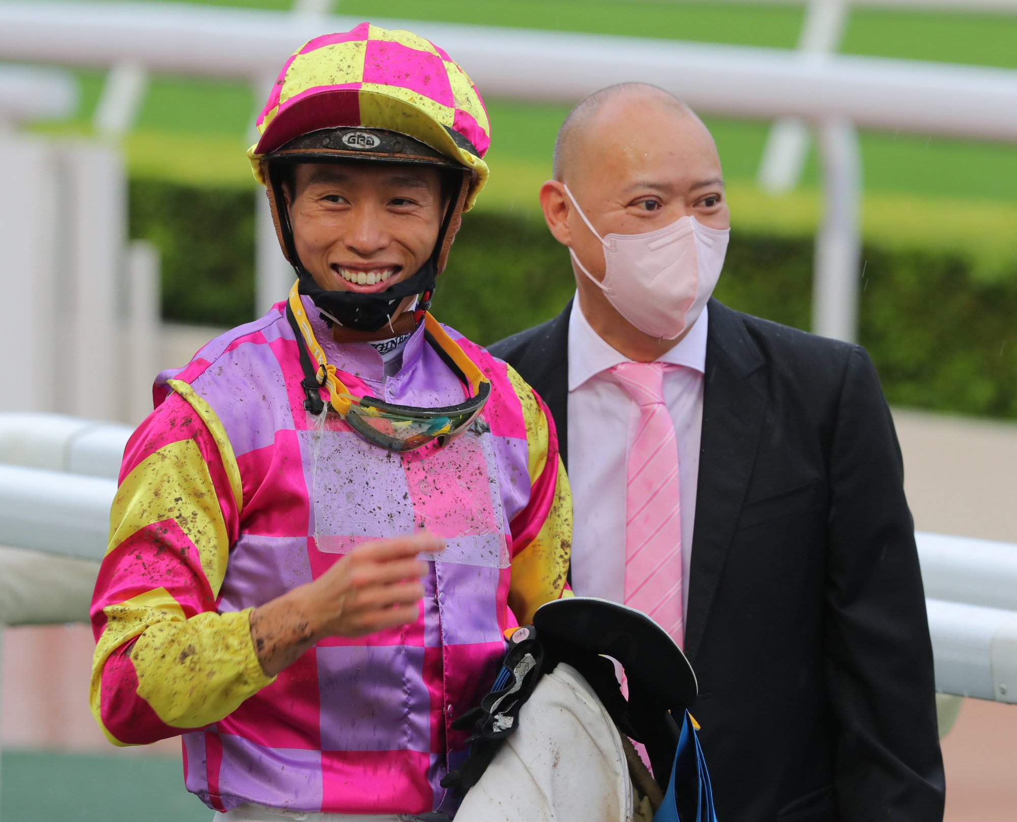 Jockey Vincent Ho and trainer Chris So are all smiles after a victory.