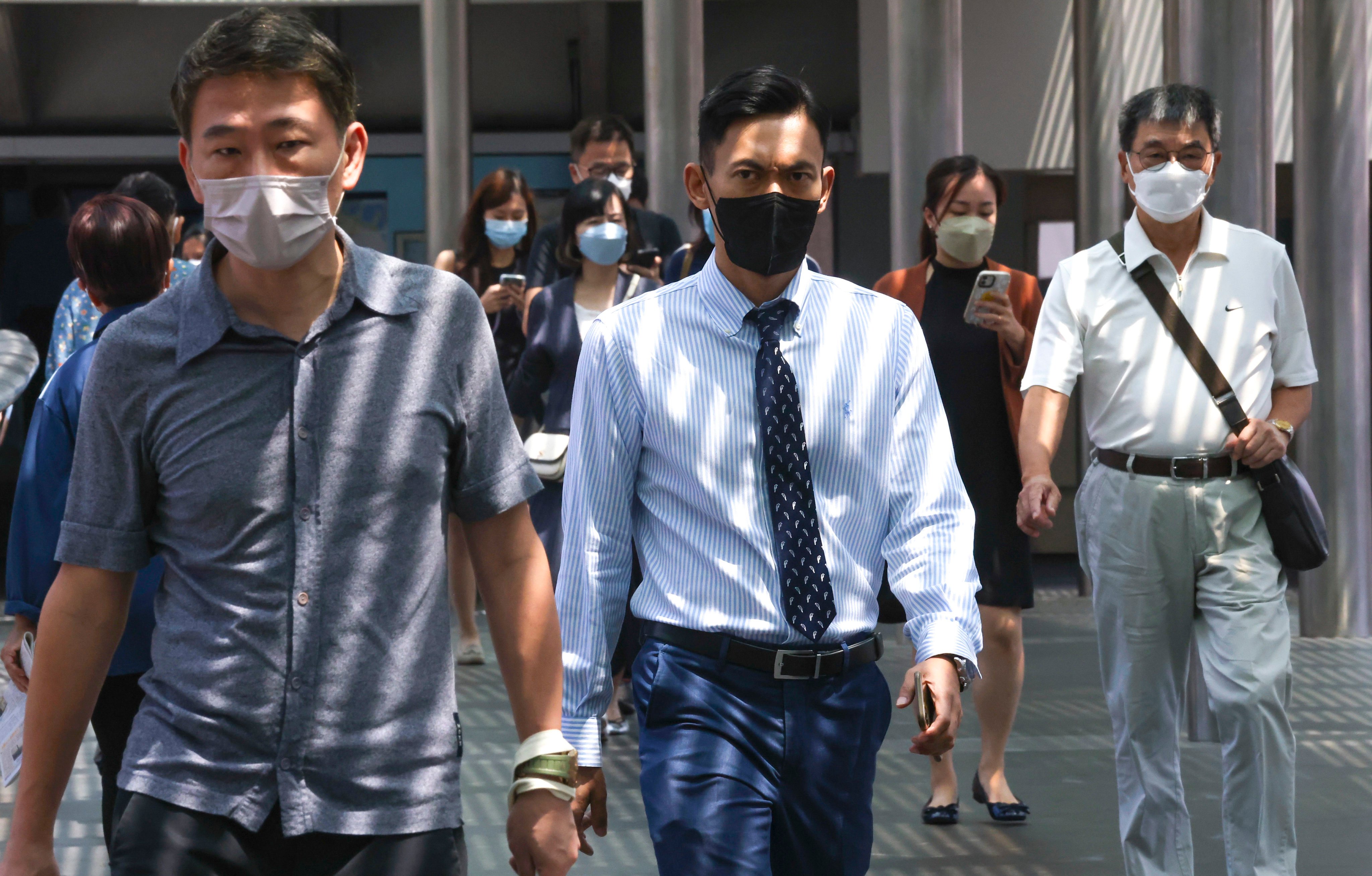 Masked pedestrians in Hong Kong’s Central. The city has one of the world’s toughest pandemic systems and has only recently eased curbs extensively. Photo: Jonathan Wong