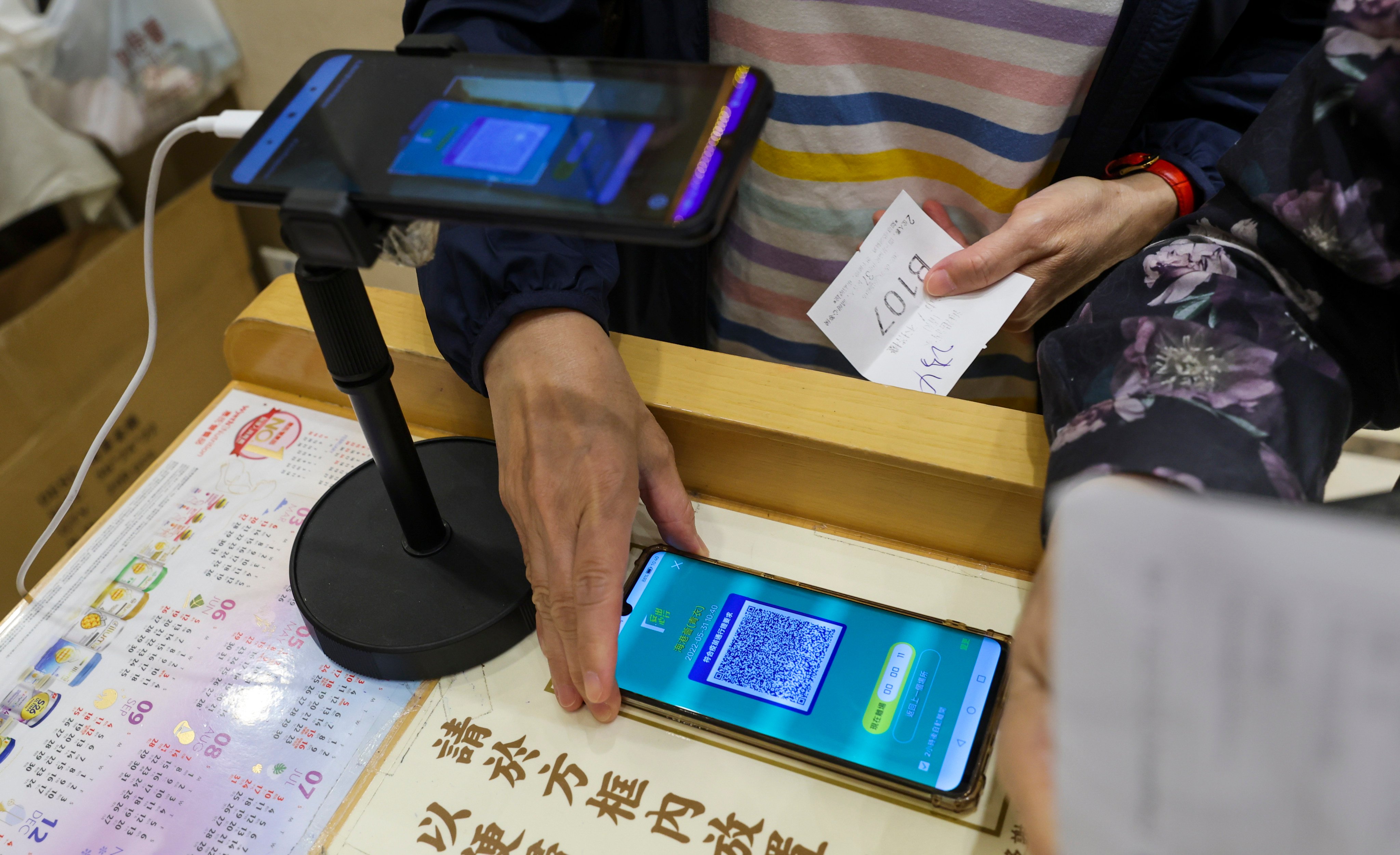 A customer scans the ‘Leave Home Safe’ app before entering a restaurant. Photo: Yik Yeung-man