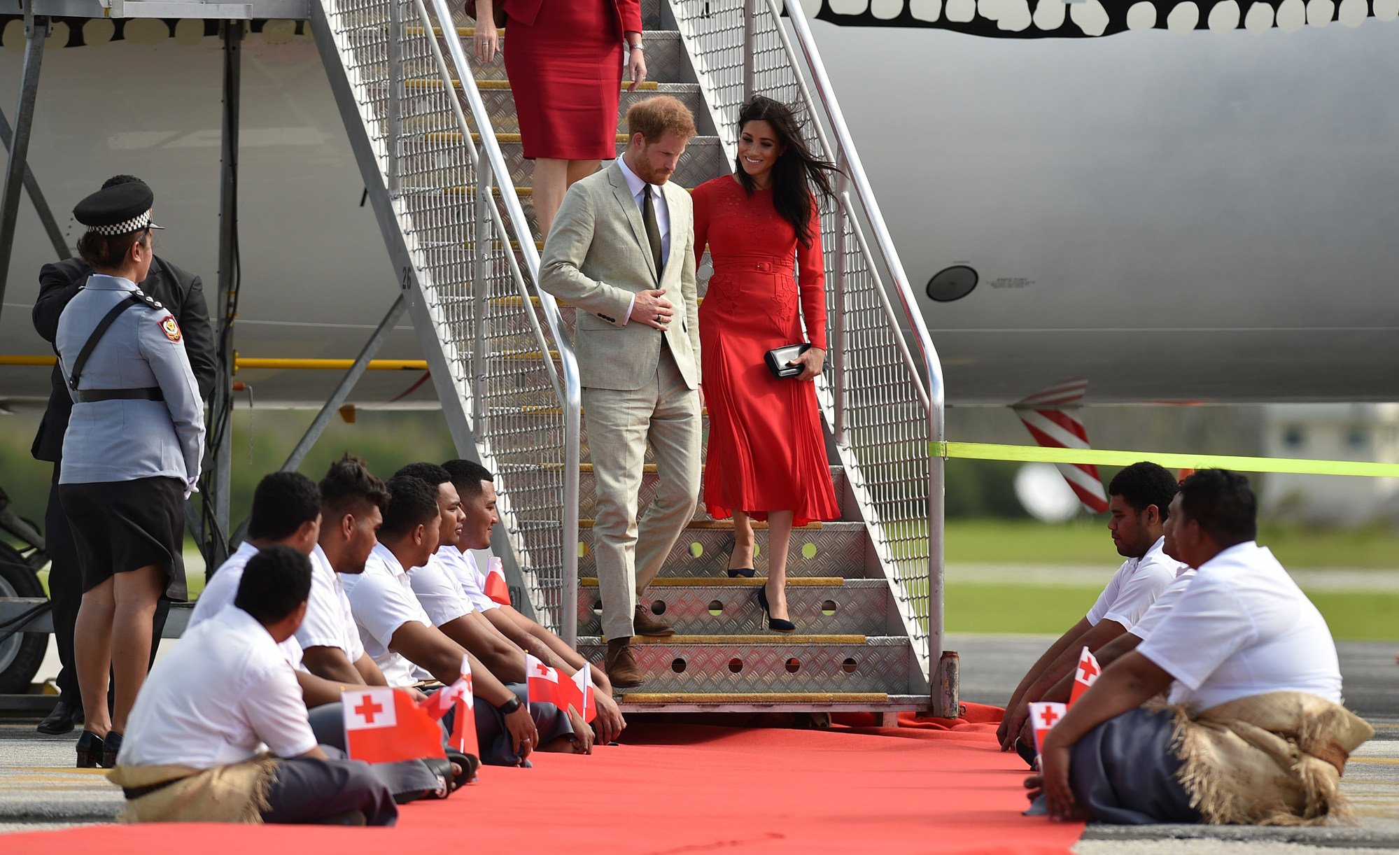 Britain’s Prince Harry and his wife Meghan, the Duchess of Sussex arrive at Fua’amotu airport in Tonga in October 2018. Photo: AFP