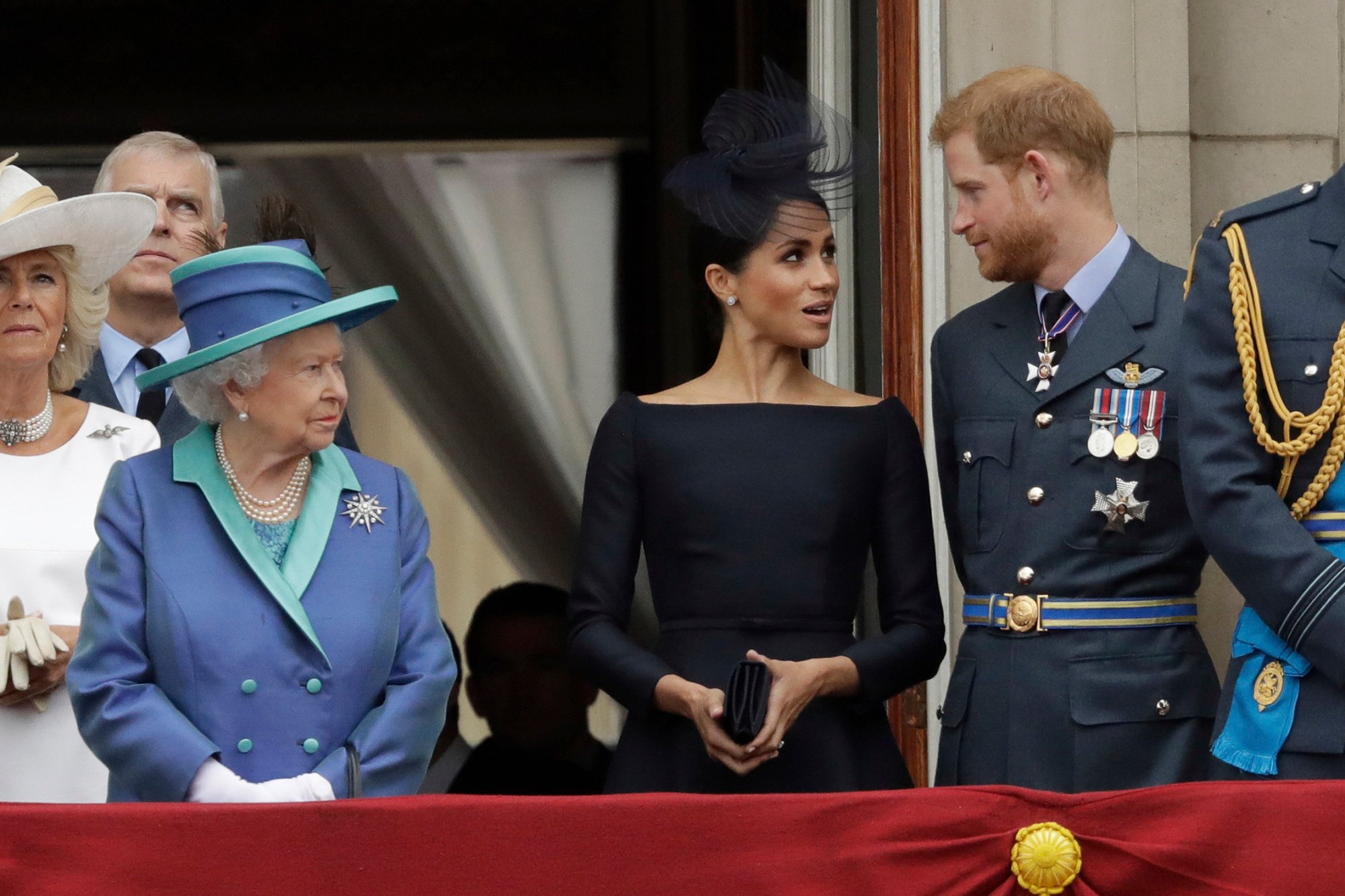Britain’s Queen Elizabeth, Meghan, the Duchess of Sussex and Prince Harry stand on a balcony to watch a fly-past of Royal Air Force aircraft pass over Buckingham Palace in London, in July 2018. Photo: AP Photo
