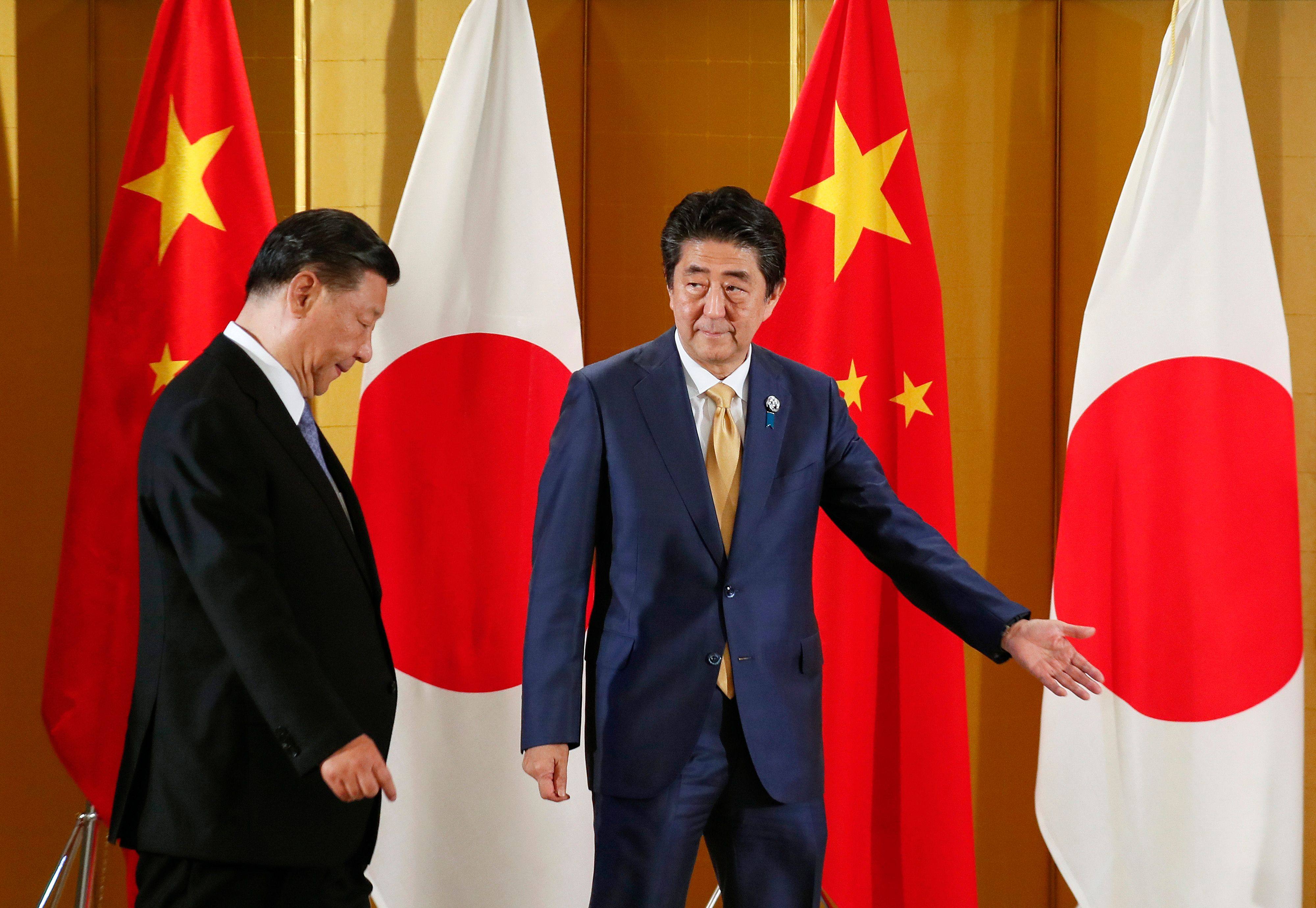Chinese President Xi Jinping (left) is escorted by then Japanese prime minister Shinzo Abe at the start of their talks in Osaka on June 27, 2019, ahead of the G20 summit. Photo: AFP