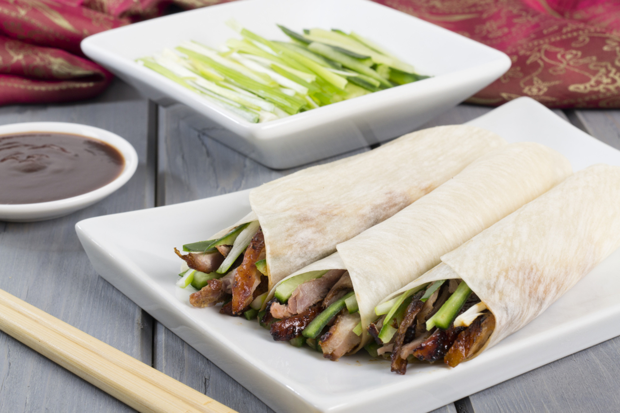 Peking duck served with cucumber, spring onion and hoisin sauce, wrapped in pancakes. Photo: Shutterstock/File
