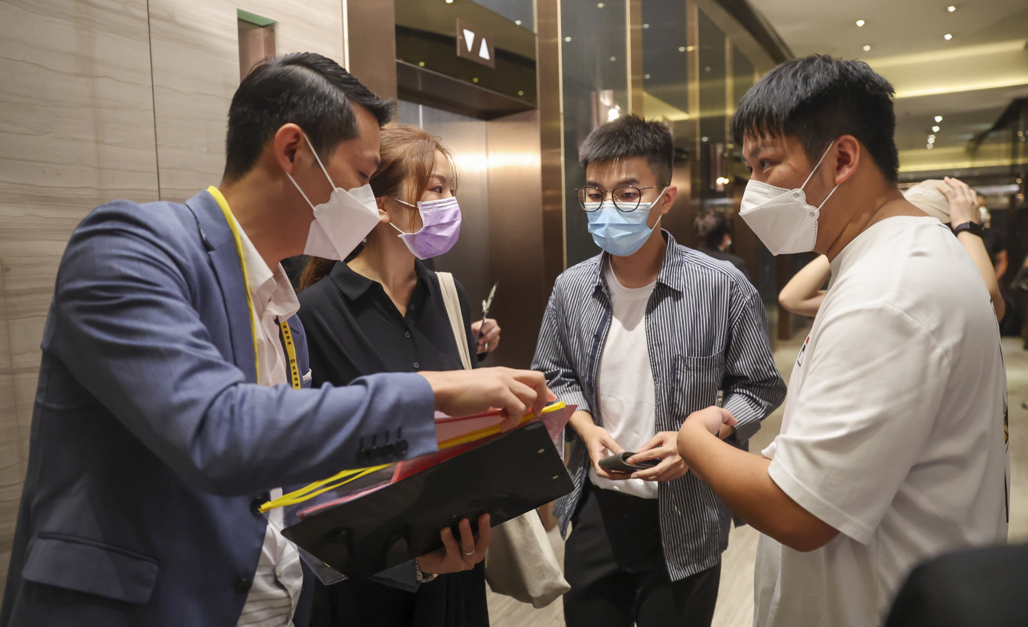 Potential buyers line up at the sales office of Henderson Land Development’s One Innovale-Bellevue project at Mira Place in Tsim Sha Tsui on October 2, 2022. Photo: Edmond So