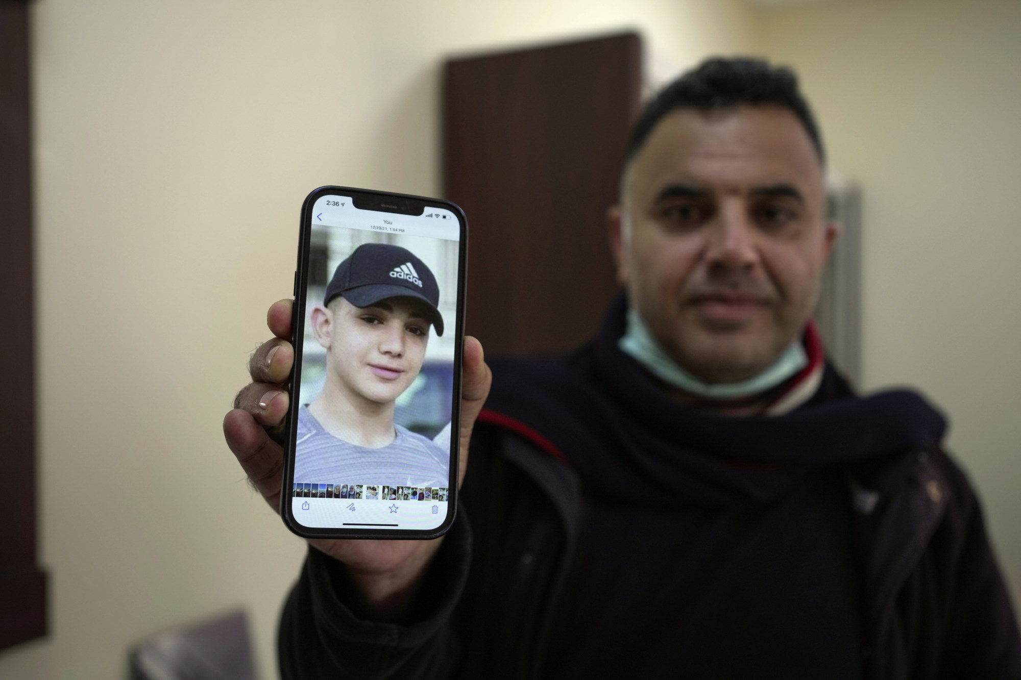 Muamar Nakhleh, father of Amal Nakhleh, a Palestinian teenager with a rare neuromuscular disorder, who had been held without charge for a year, shows his photo. Amal Nakhleh was released in May. Photo: AP