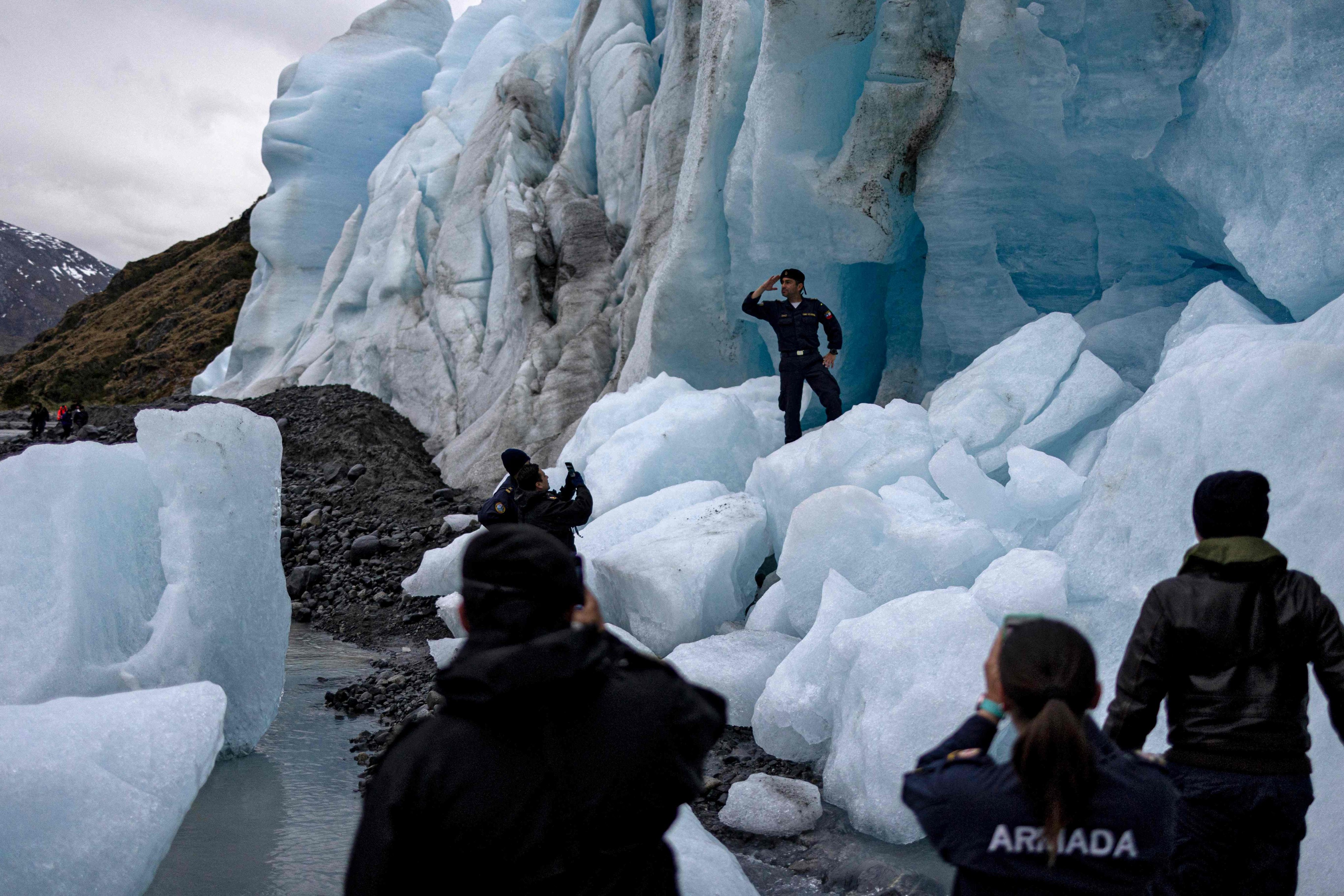 Researchers take photos at Fouque glacier in Chile on November 30, 2021. Photo: AFP
