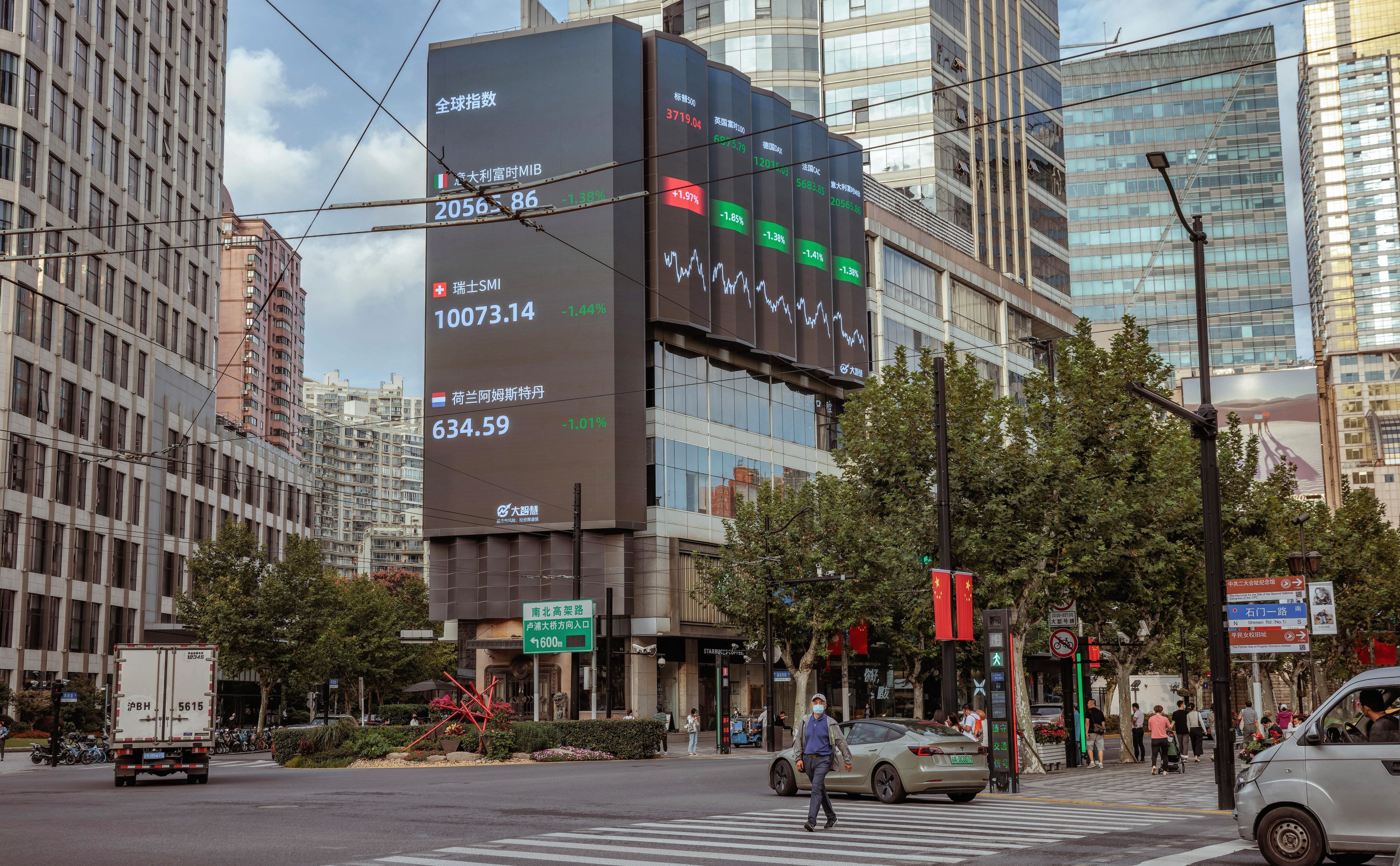 A man walks past the large screen showing stock and currency exchange data in Shanghai on September 29. The yuan hit a record low against the US dollar on September 28, the weakest since the global crisis in 2008. The central bank is taking steps to rein in yuan weakness. Photo: EPA-EFE