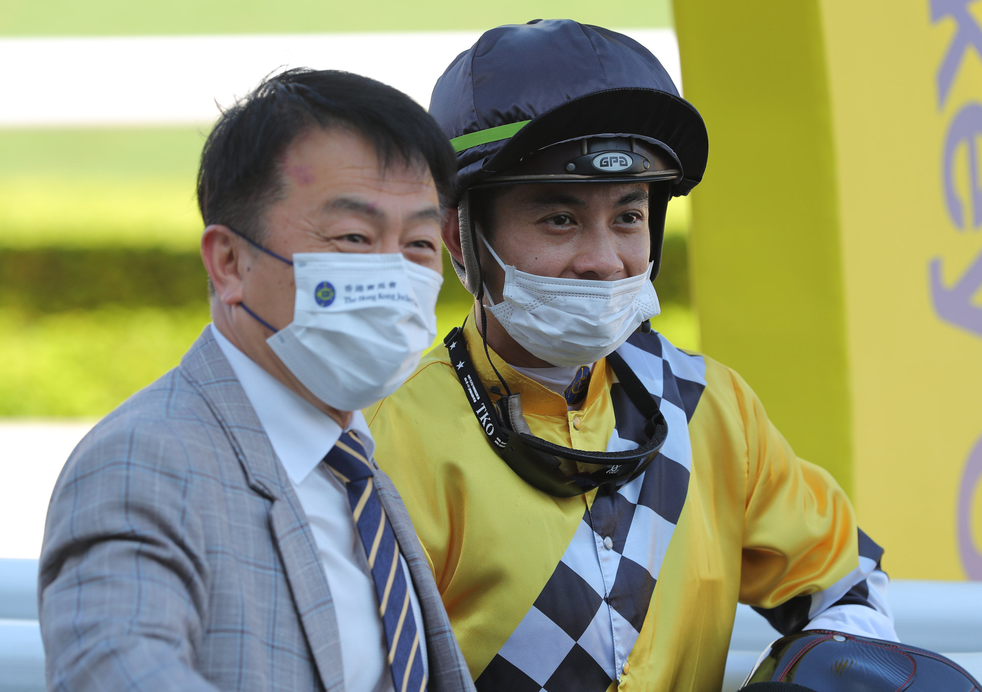 Trainer Ricky Yiu and jockey Derek Leung celebrate a victory.