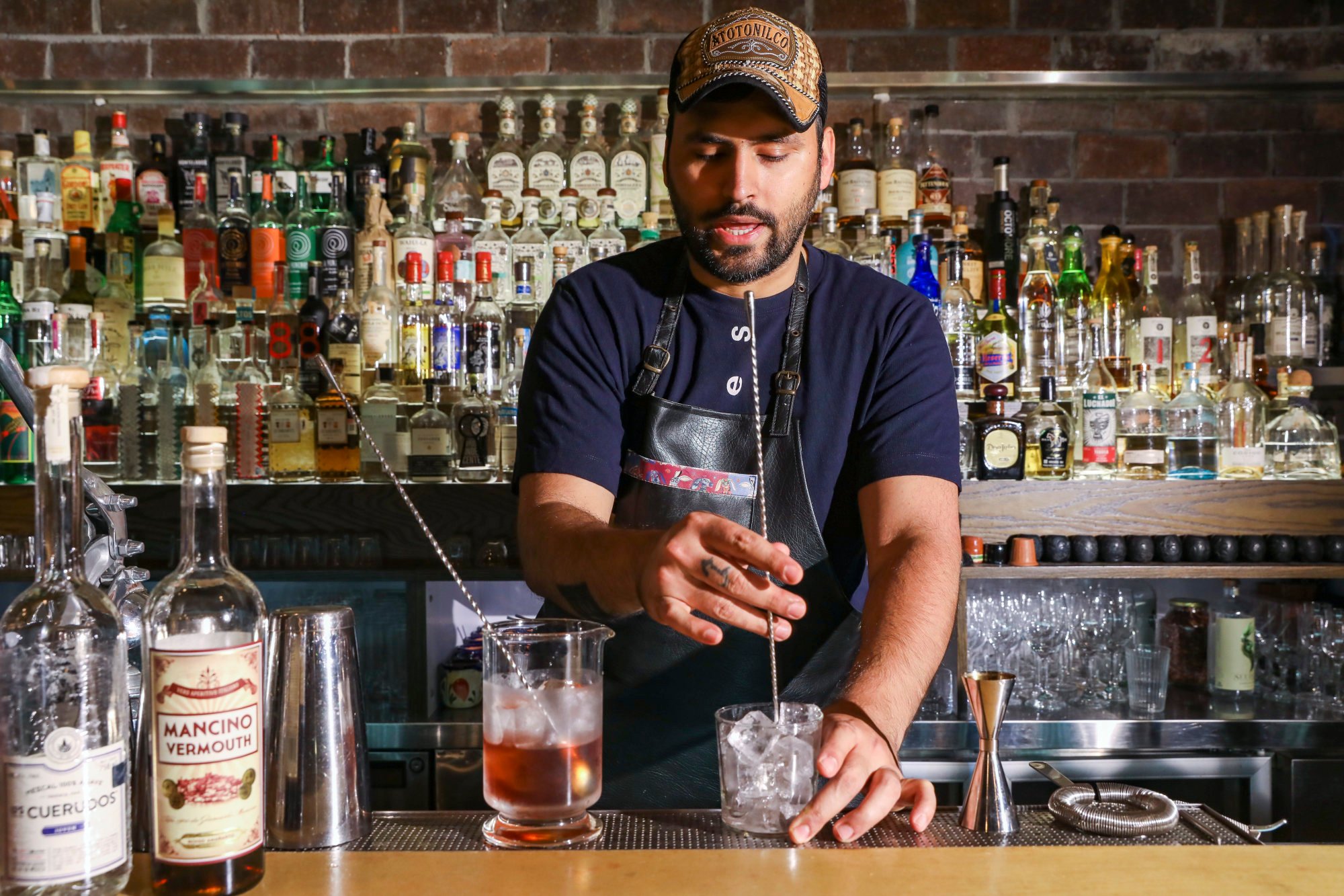 Coa bartender Jay Khan mixing a drink. Photo: K. Y. Cheng