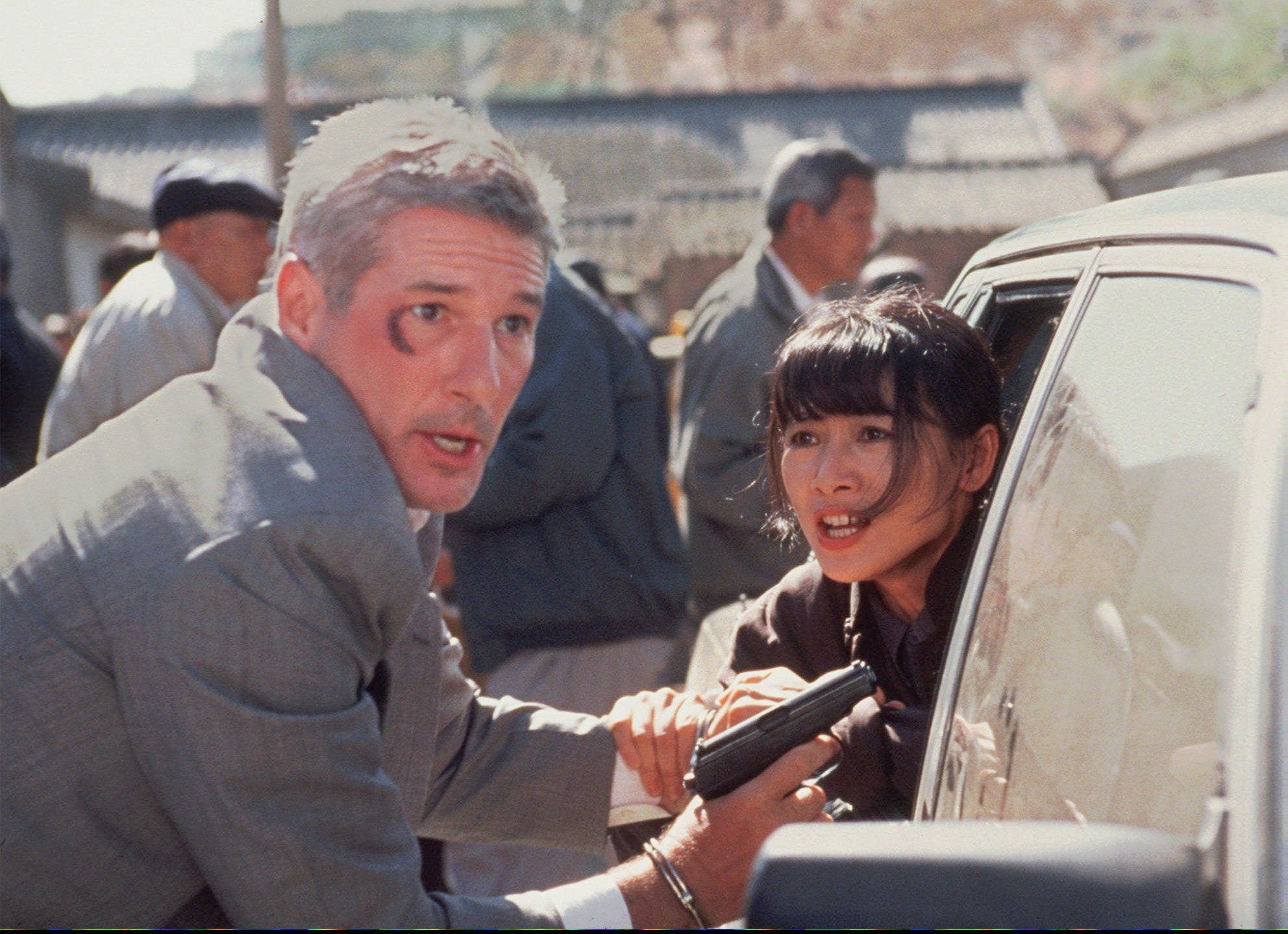 FOR USE WITH FEATURE PACKAGE FOR SUNDAY NOV. 2 --Chinese actress Bai Ling begs Richard Gere not to run in a scene from the movie “Red Corner,” being released Friday, Oct. 31.  “Red Corner,” an account of an American executive framed for murder and railroaded by the Chinese judicial system, is one of five films being released that deal with Chinese oppression.  The fresh batch of China-related films is motivated by genuine concern about international human rights and the film business’ unique position to advocate for change. (AP Photo/Richard Foreman Jr., HO)