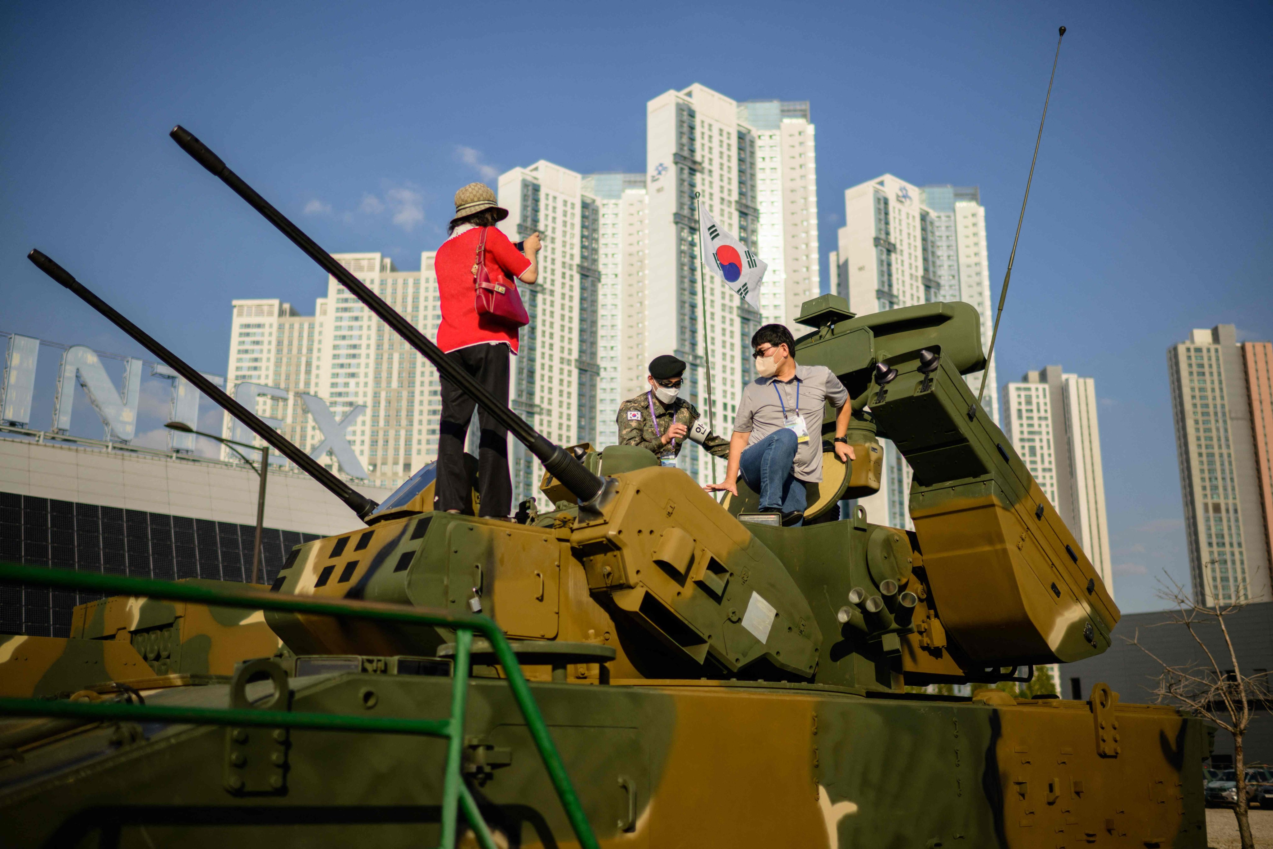 Visitors take turns getting a hands-on look at a 30mm self-propelled anti-aircraft system during last month’s defence expo in Goyang, South Korea. Photo: AFP
