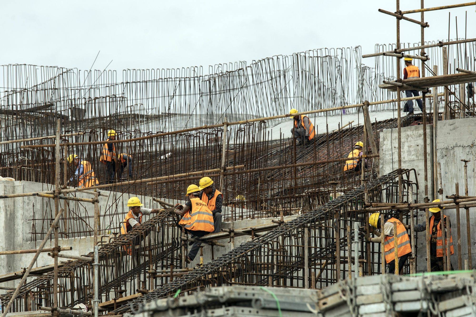 Workers at a construction site for the World Expo Culture Park in Shanghai on September 27. For decades China has invested an amount equal to 40-50 per cent of its annual GDP. But as the productivity benefits of additional investment declined, the debt burden has risen. Photo: Bloomberg