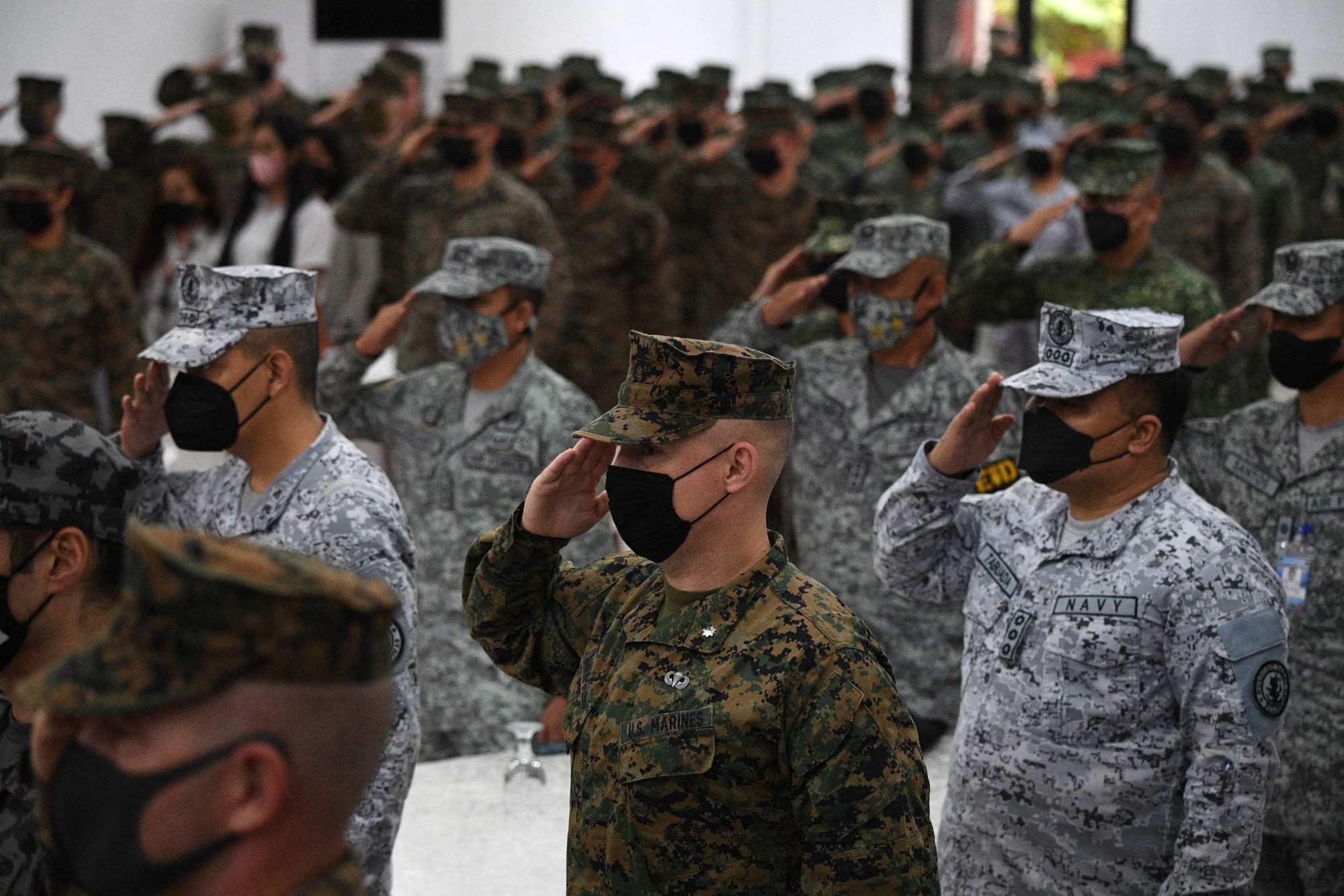 Philippine and US marines salute while their national anthems are played during the opening ceremony of the joint military exercise “Kamandag” at the Philippine marines headquarters in Taguig, suburban Manila on October 3, 2022. Photo: AFP