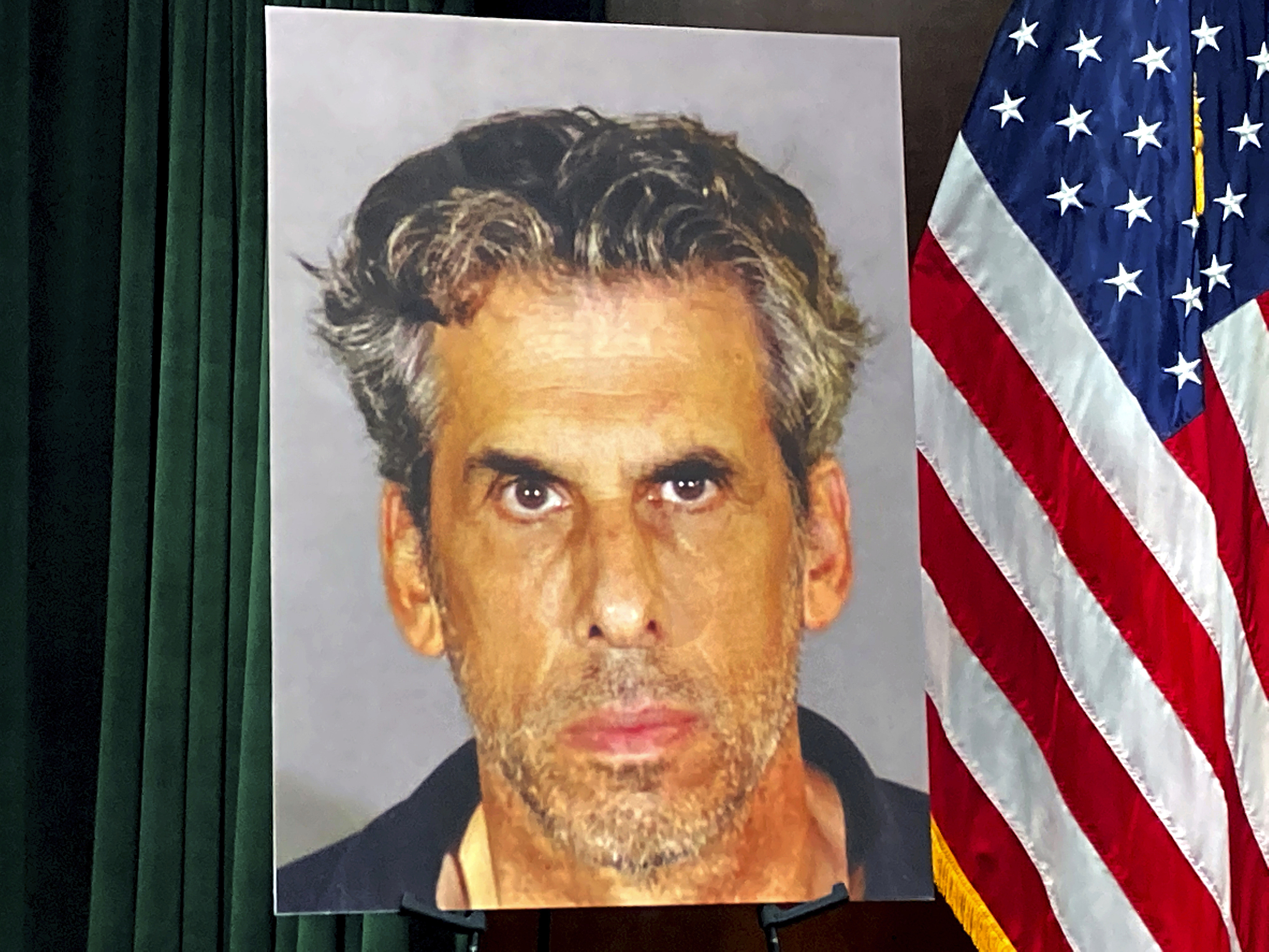 A photo of TV producer Eric Weinberg is displayed before a news conference to announce sexual assault charges against him in Los Angeles. Photo: AP
