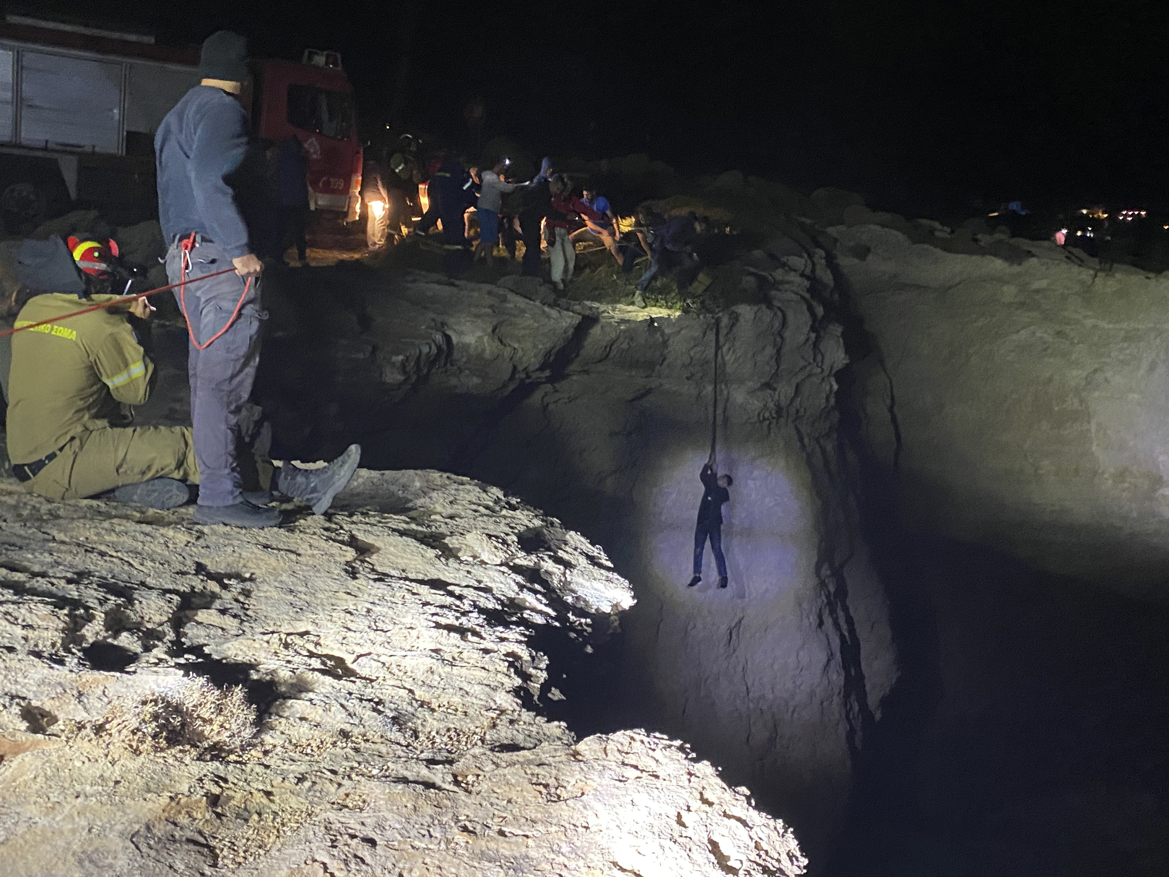 Authorities and local residents save a migrant during a large-scale rescue operation on the island of Kythira. Photo: AP