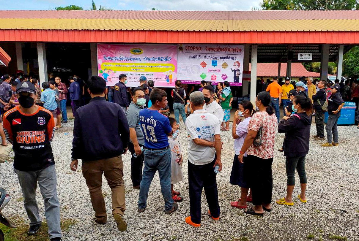People gather outside a day care centre in Nong Bua Lamphu after a shooting. Photo: Handout via Reuters