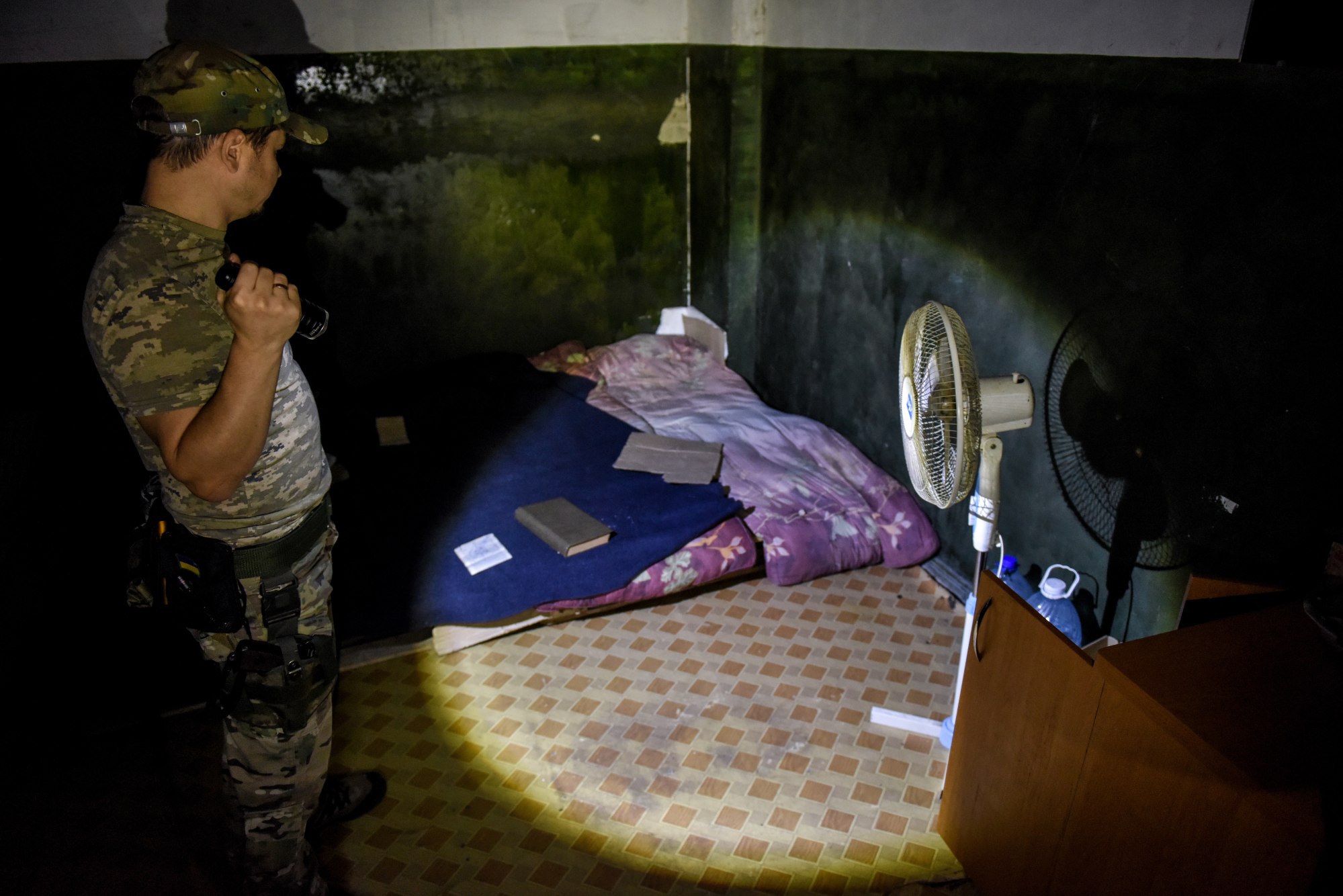 A Ukrainian serviceman shows one of the rooms allegedly used as a prison for Ukrainian servicemen and civilians in Vovchansk, in Kharkiv region. Photo: EPA-EFE