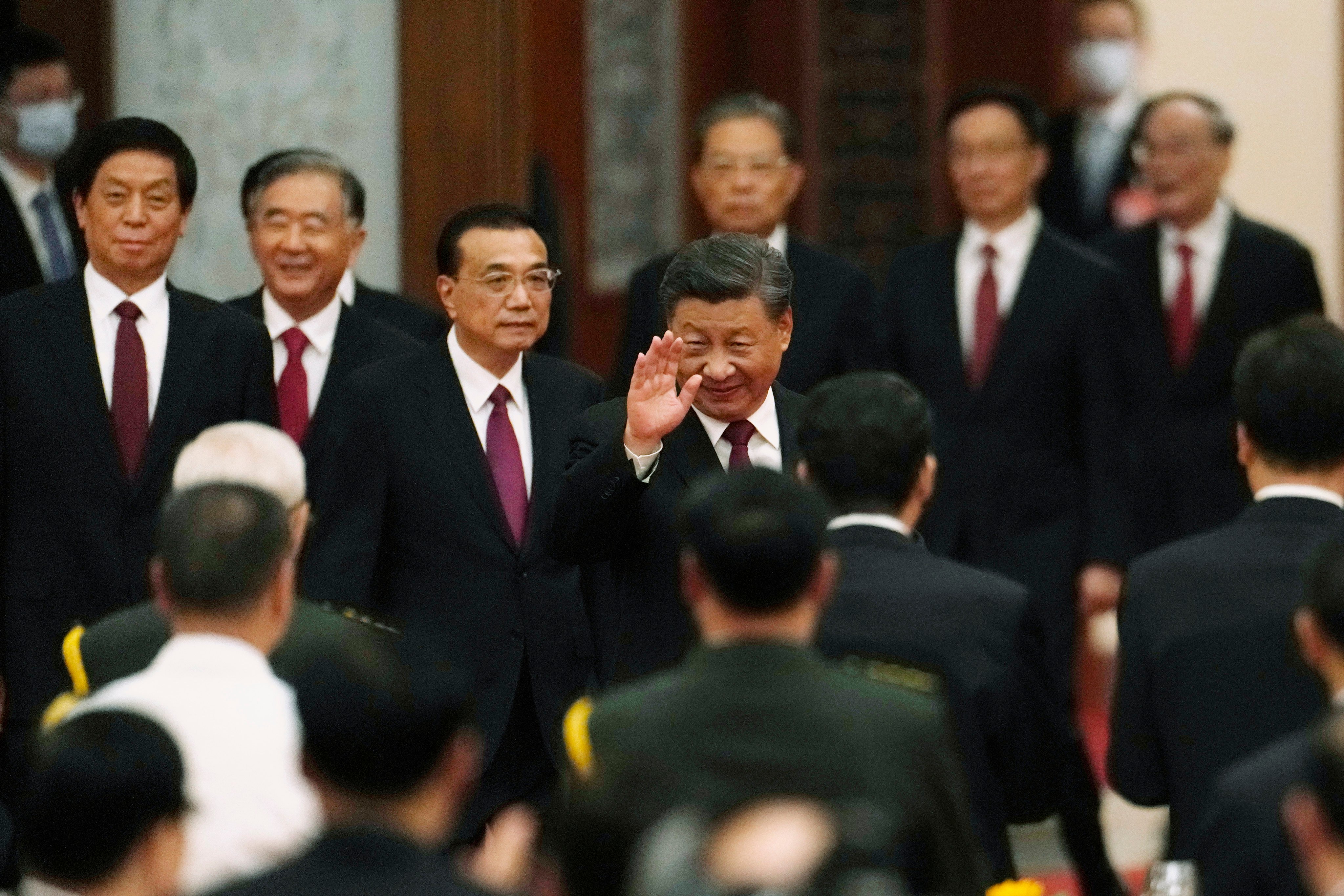 President Xi Jinping waves as he walks ahead of other members of the Politburo Standing Committee during a dinner reception at the Great Hall of the People in Beijing on September 30, the eve of the National Day holiday. Photo: AP