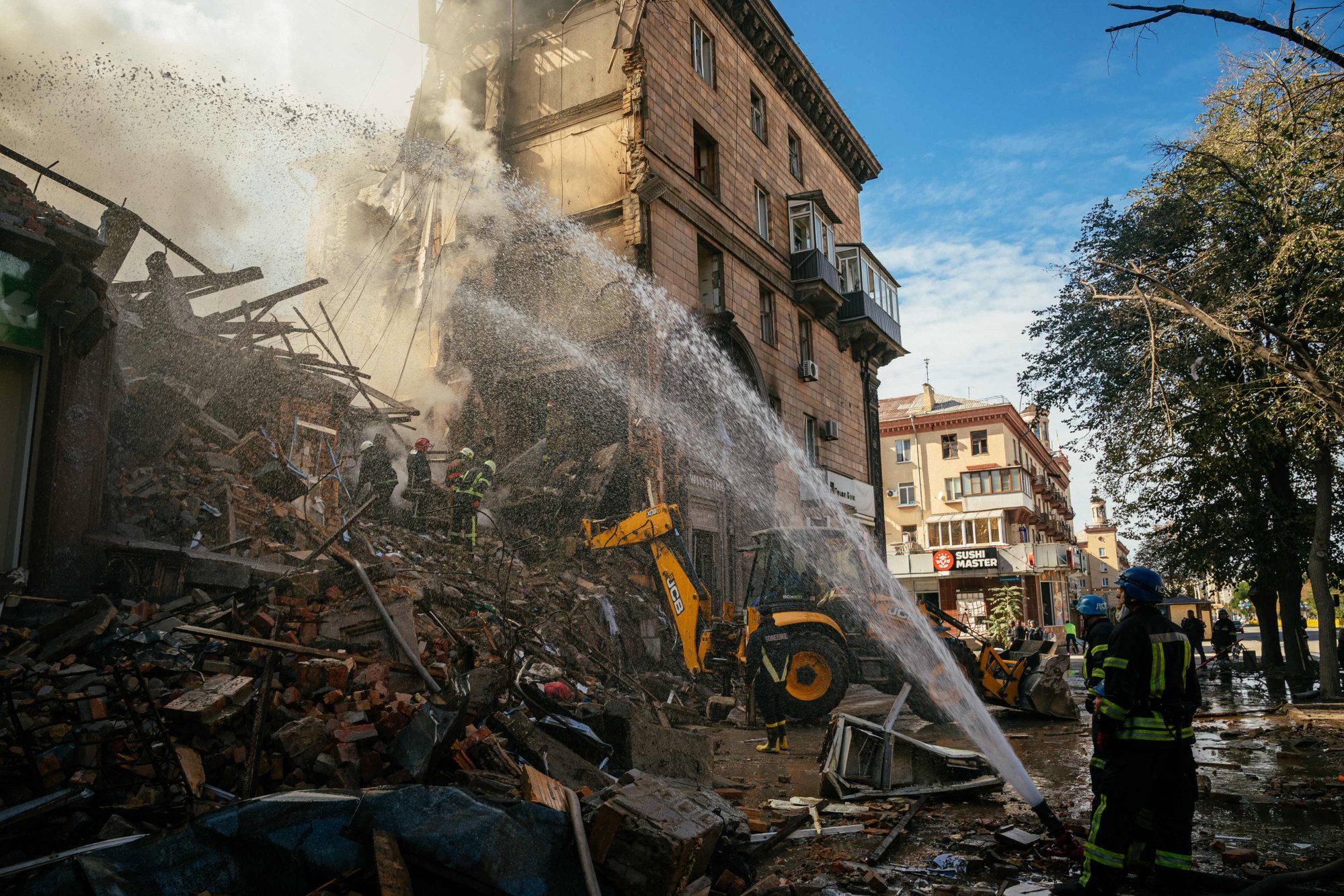 Ukrainian firefighters put out a fire after a strike in Zaporizhzhia on October 6. Photo: AFP