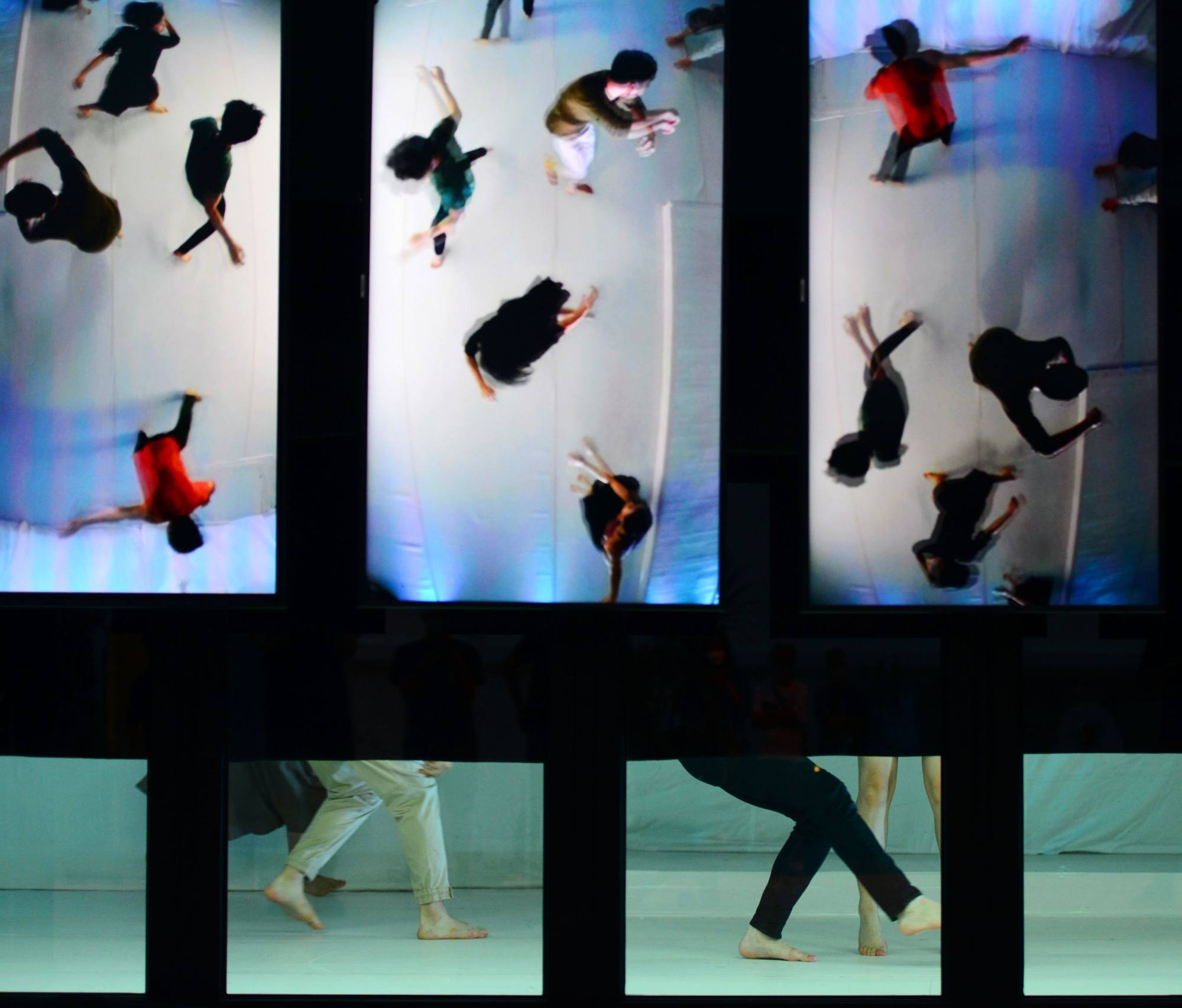 A scene from “Meeting In-Between Time”, a City Contemporary Dance Company production at The Pokfulam Farm. A real-time video feed shown is on screens that obscure the audience’s view of the dancers save for their lower legs. Photo: Yvonne Chan