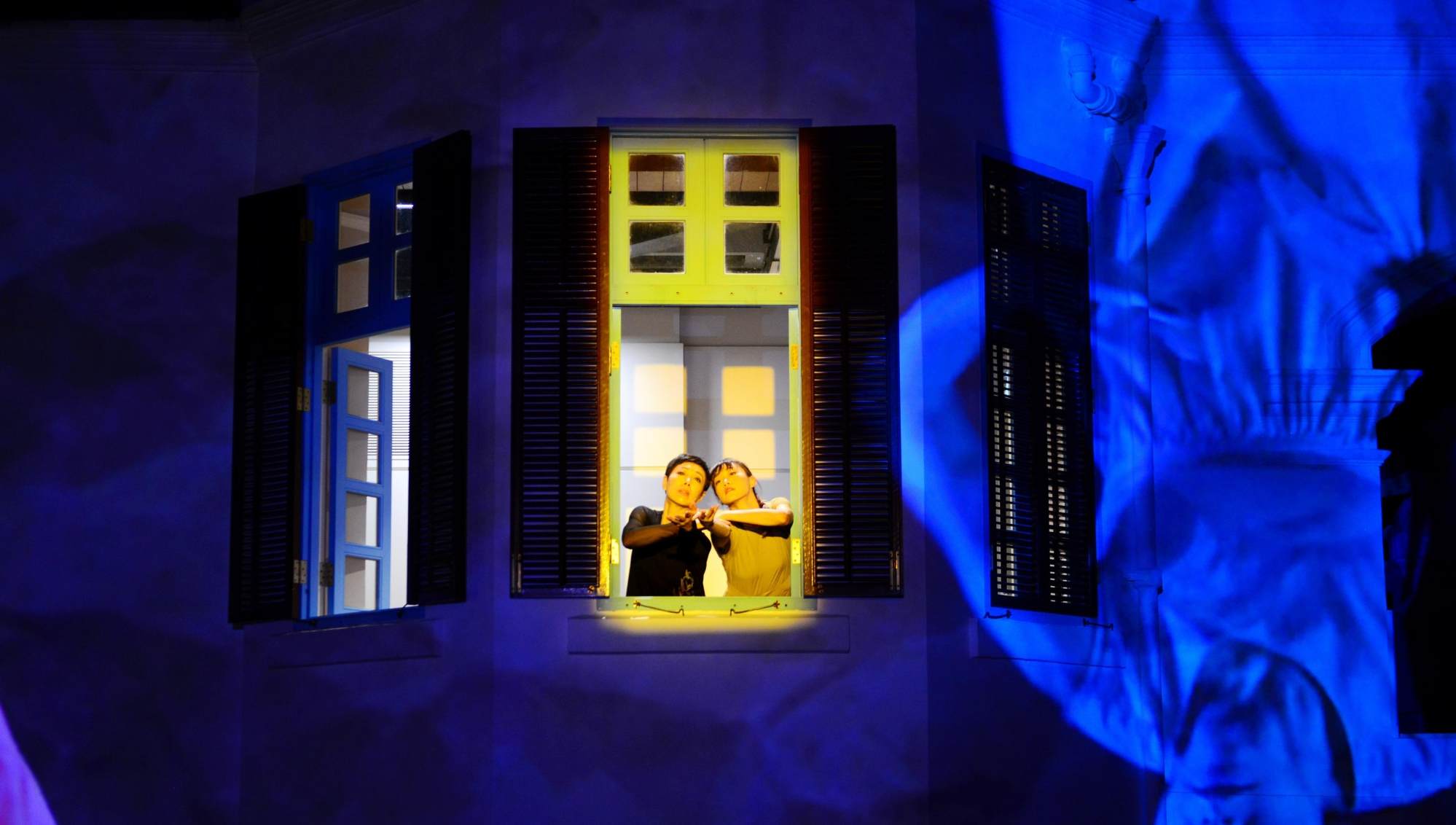 A scene from “Meeting In-Between Time”, a City Contemporary Dance Company production. Qiao Yang and Shirley Lok look out of an upper floor window of the former Dairy Farm staff quarters in Pok Fu Lam, Hong Kong. Photo: Yvonne Chan