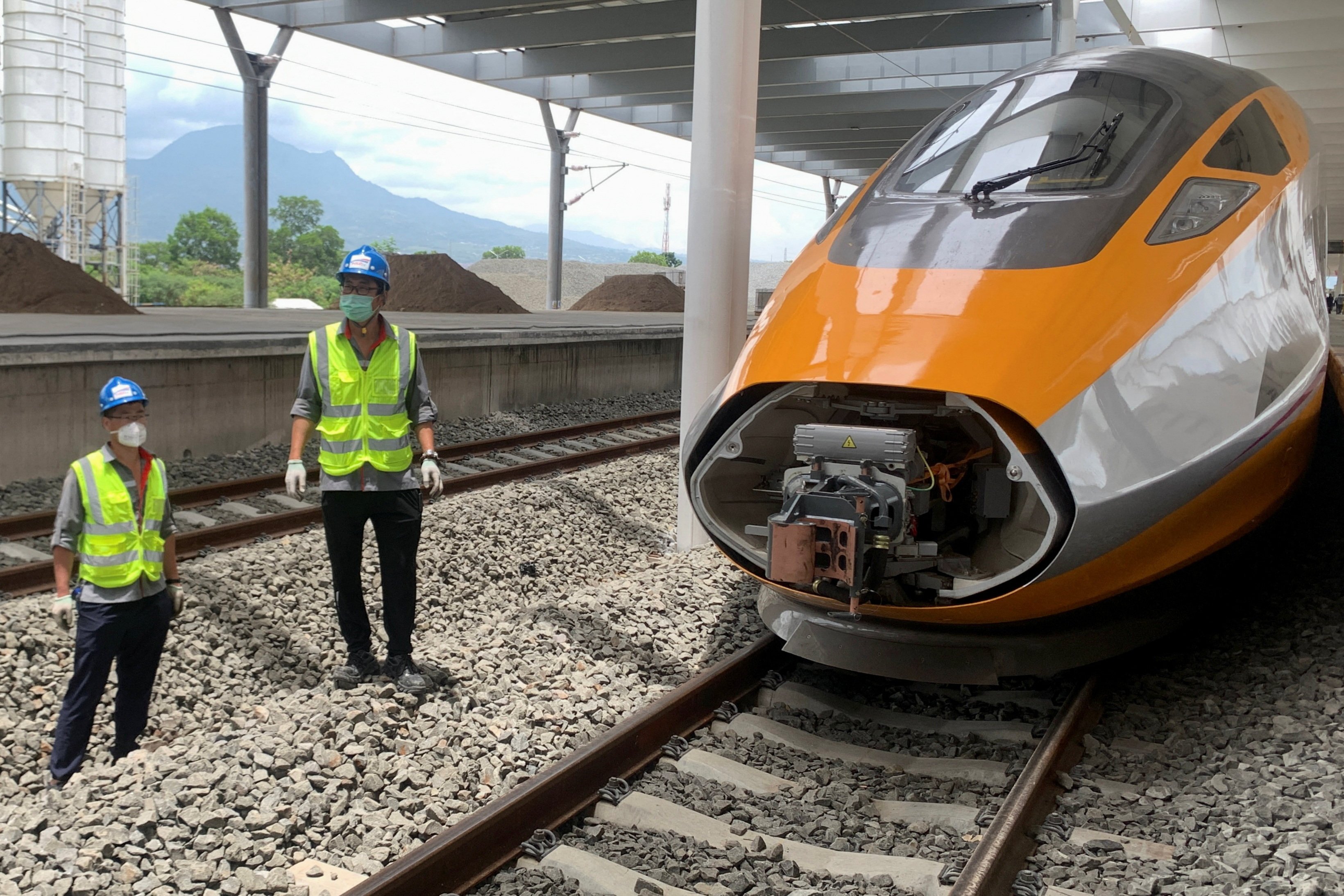 Workers stand beside a high-speed train in Bandung, Indonesia, on Thursday. Photo: Reuters
