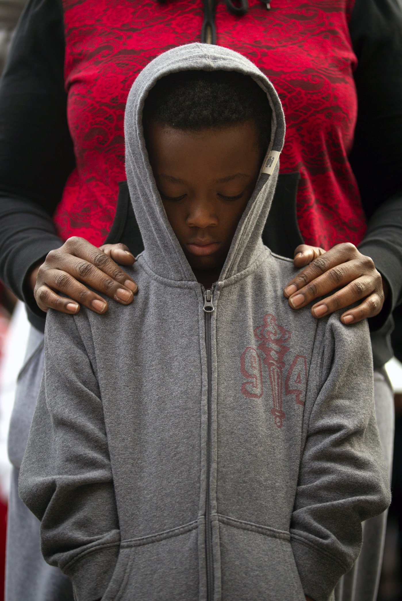 A boy stands with his mother during a “One Thousand Hoodies March” in Minneapolis for Martin in 2012. Photo: AP