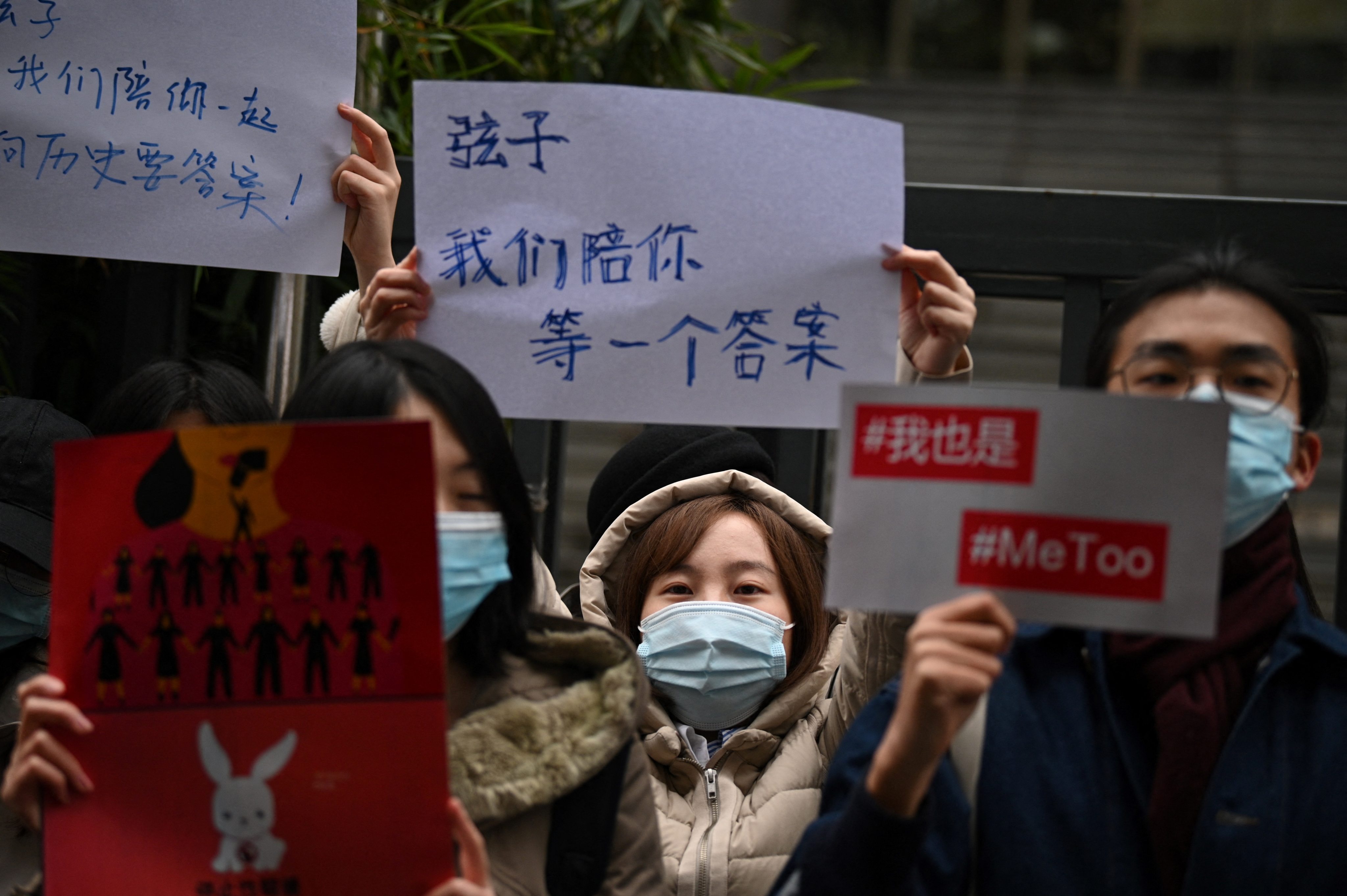 Supporters of screenwriter Zhou Xiaoxuan, who is popularly known by her pen name Xianzi, hold placards that say “#MeToo” and “Xianzi, we will wait with you for an answer” outside the Haidian People’s Court in Beijing on December 2, 2020. Although there has been legal progress on women’s rights in China, Zhou lost her landmark sexual harassment case against popular TV host Zhu Jun. Photo: AFP