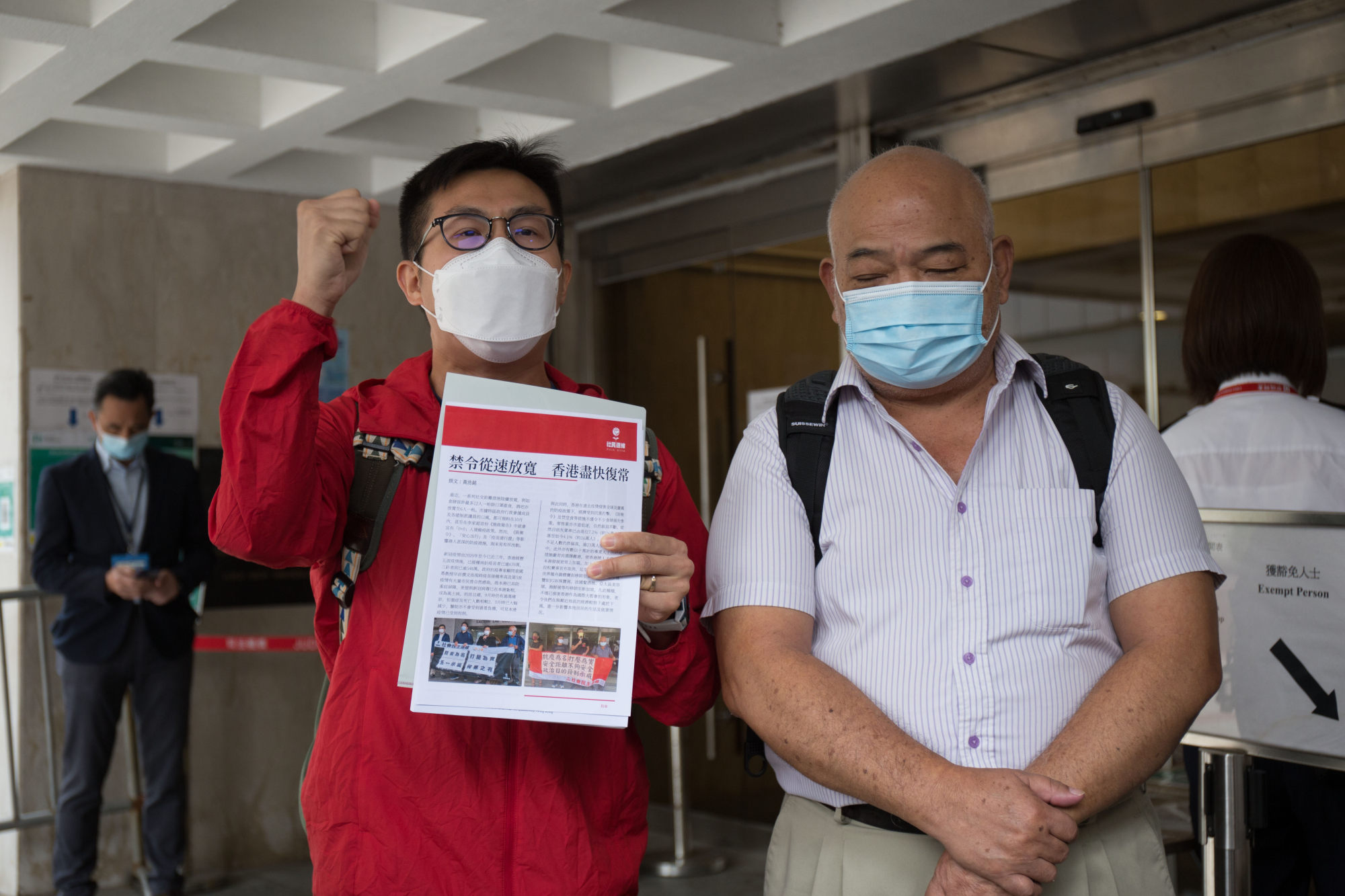 Activists Raphael Wong (left) and Tsang Kin-shing chant slogans outside the High Court on Tuesday.