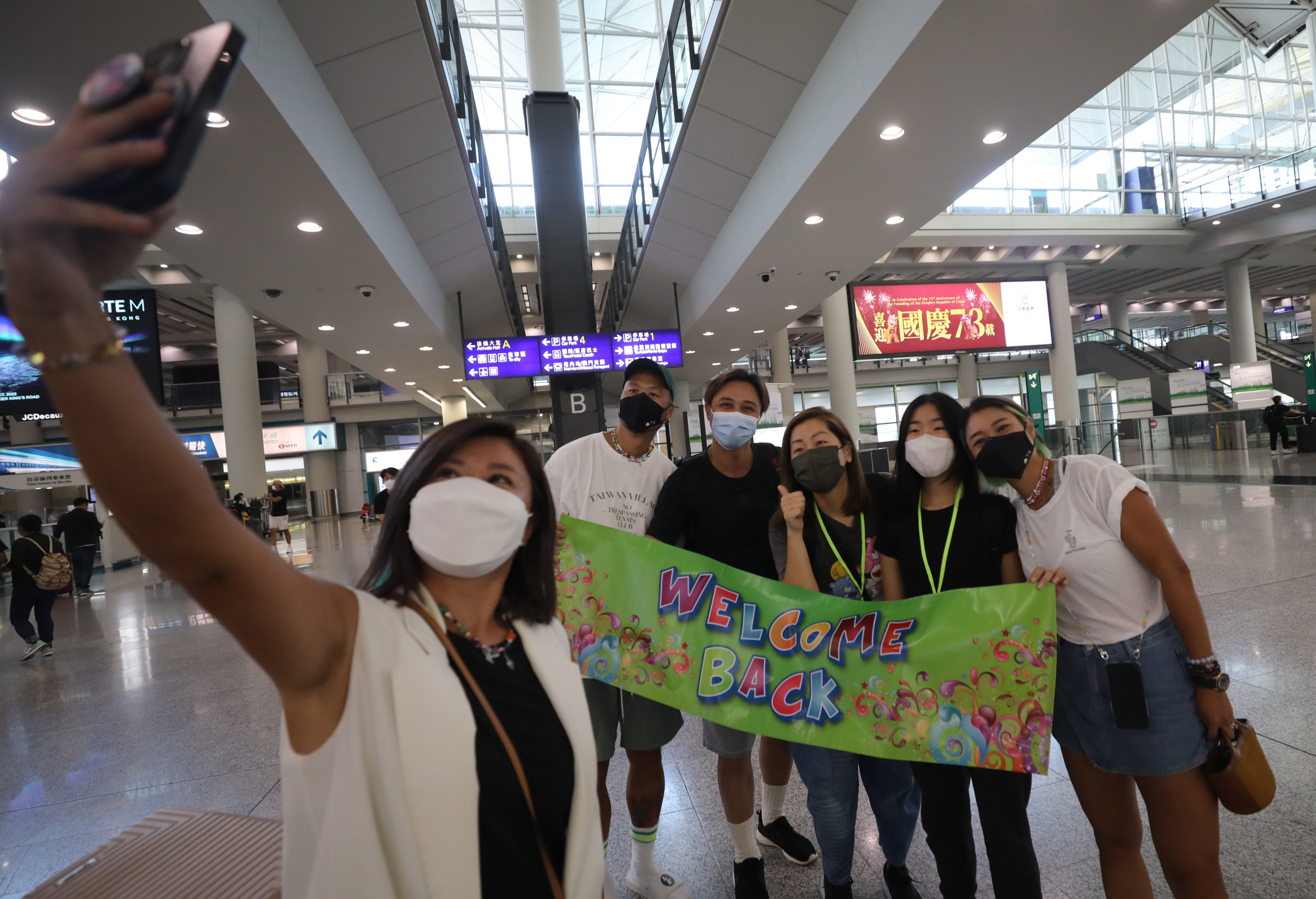 Passengers arrive at Hong Kong International Airport on October 7. While Hong Kong has taken some steps to loosen pandemic restrictions, those entering the city need to undergo a series of Covid-19 tests. Photo: Xiaomei Chen