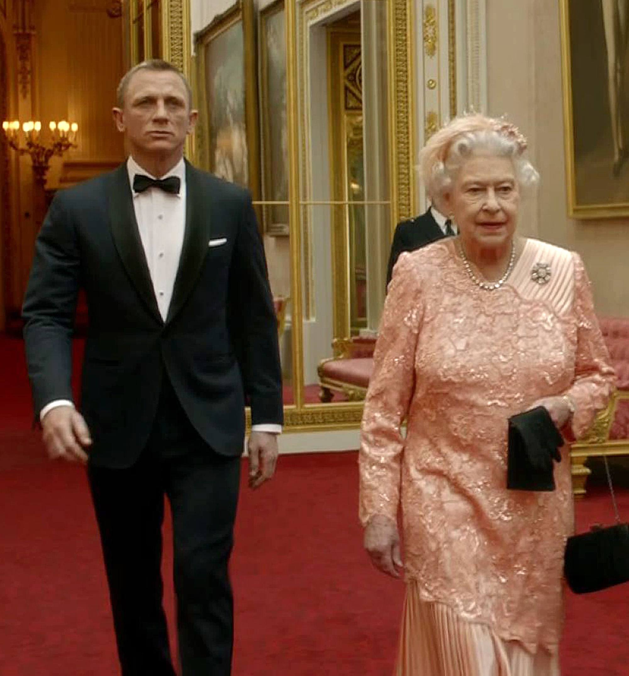 Daniel Craig escorting Queen Elizabeth through the corridors of Buckingham Palace during the opening ceremony of the London 2012 Olympic Games. Photo: AFP