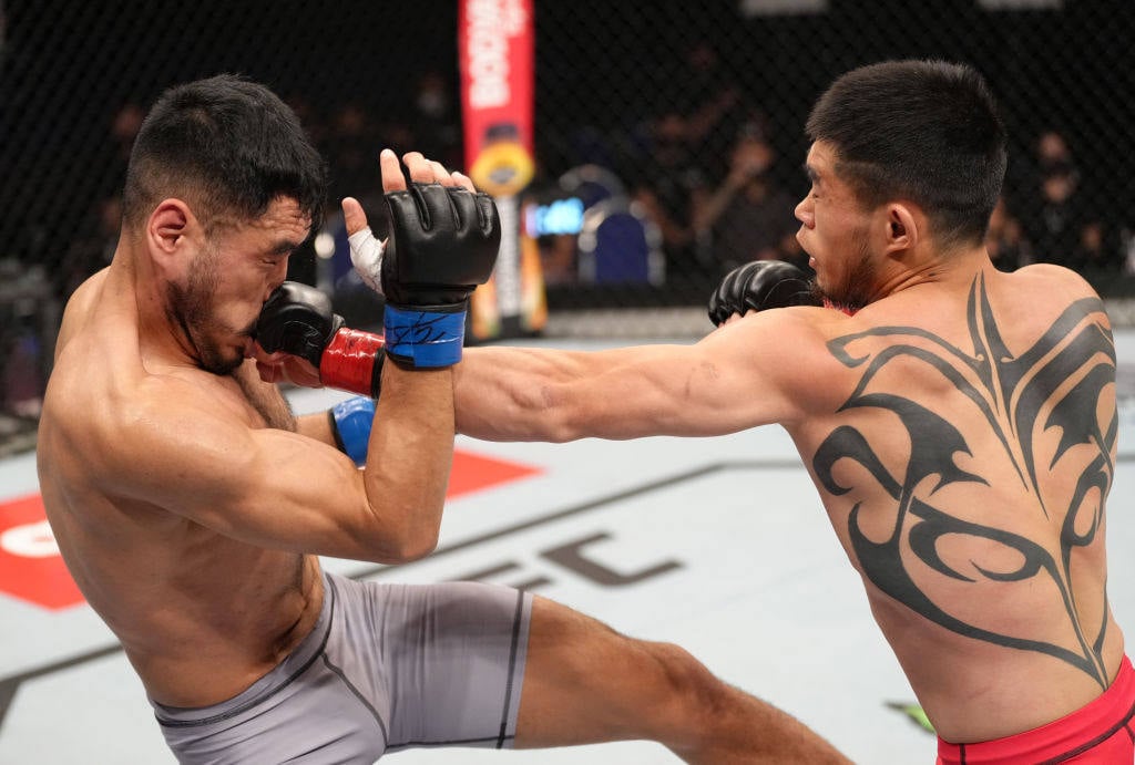 Lu Kai lands a punch on Angga during their featherweight bout in Singapore. Photo: UFC