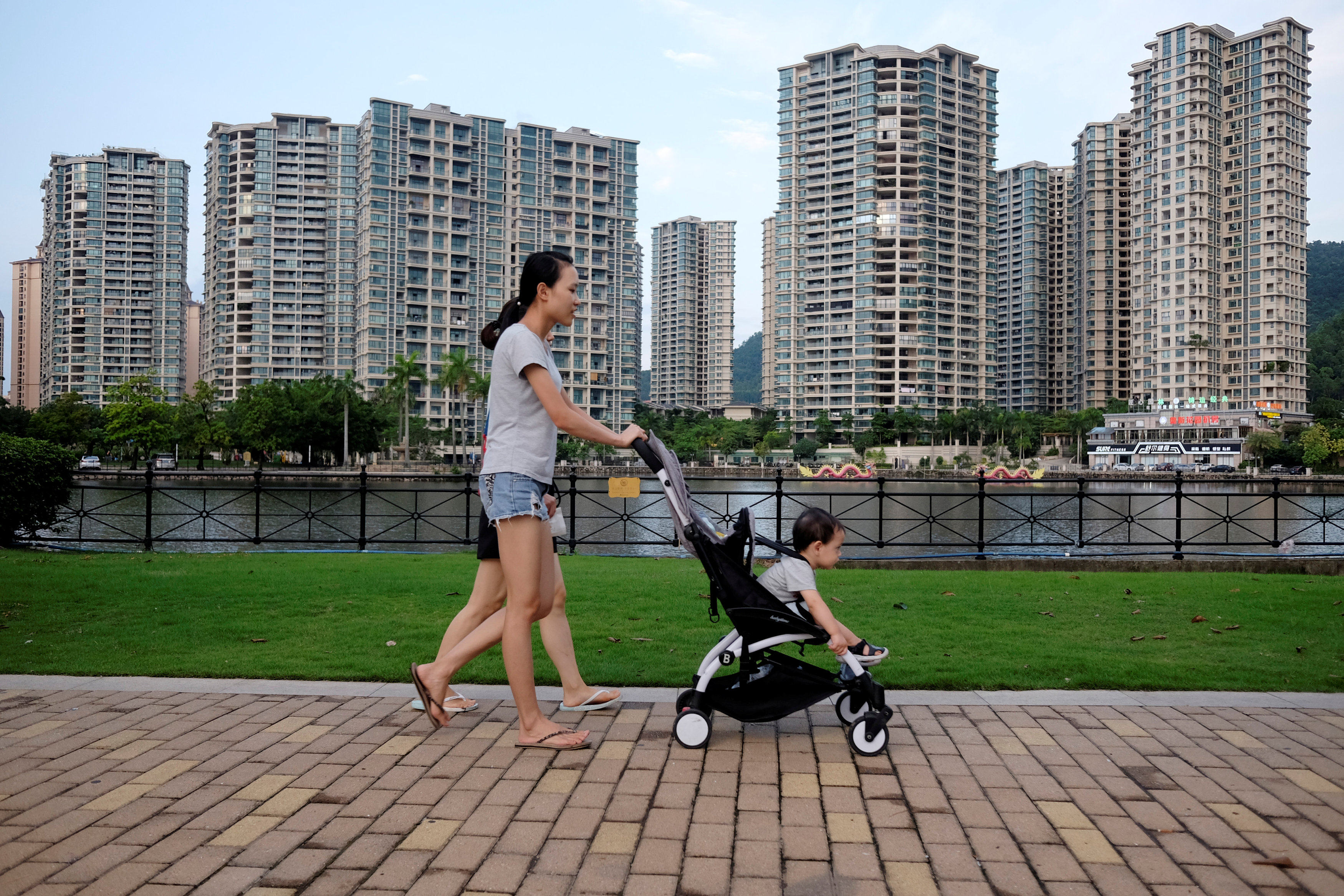 People walk past a residential property development by Agile Property in Zhongshan, China onJune 27, 2018. Photo: Reuters