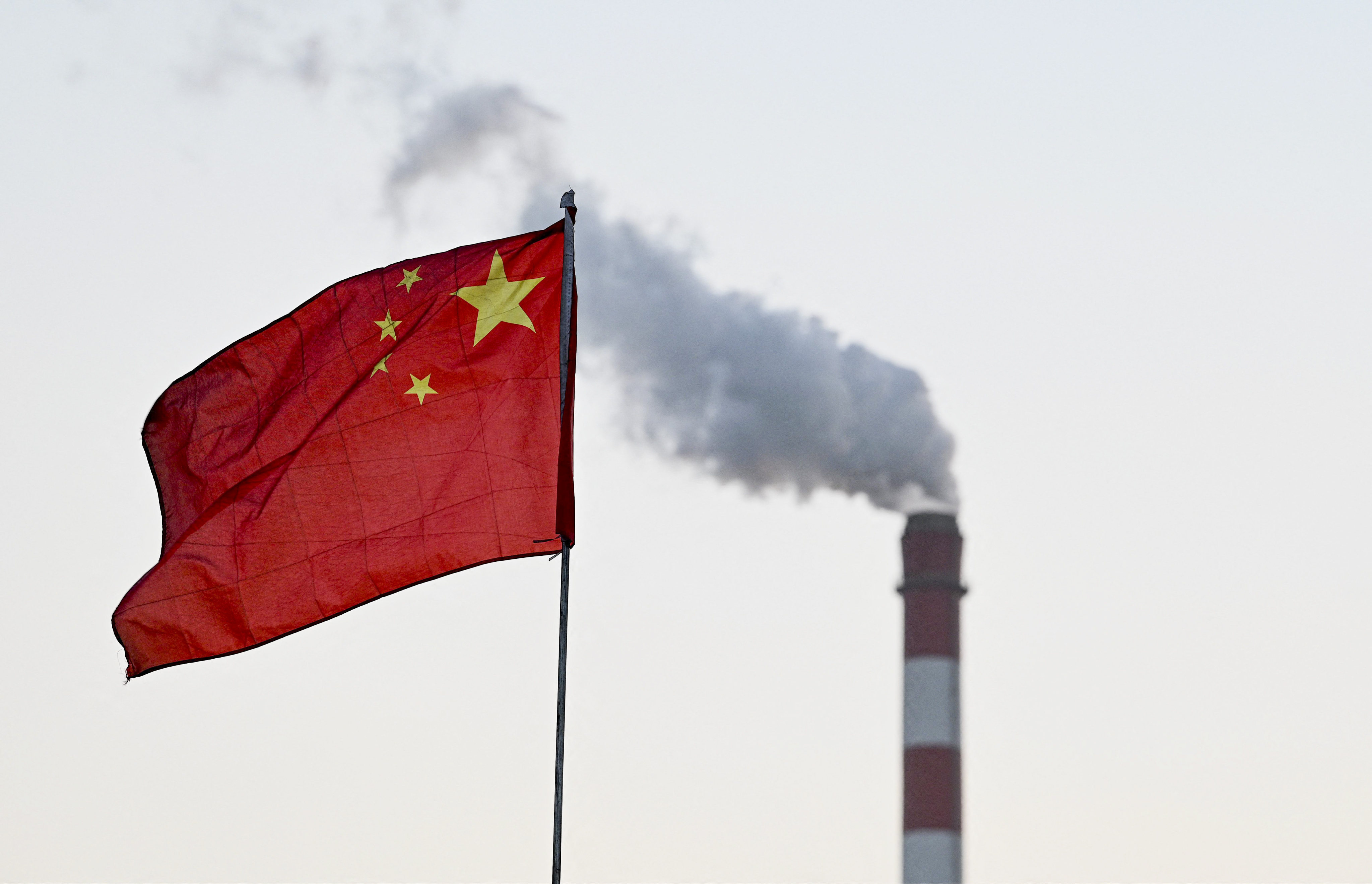 China’s national flag flutters in front of a coal-powered power station in Datong, in China’s northern Shanxi province on November 3, 2021. Photo: AFP