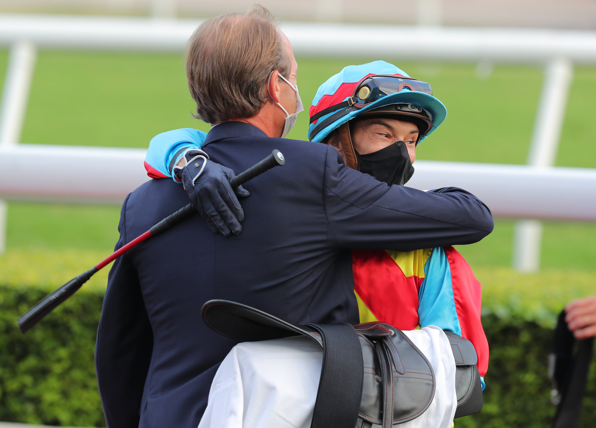 Richard Gibson and Alexis Badel embrace after Wellington’s Group Two Premier Bowl (1,200m) success at Sha Tin.