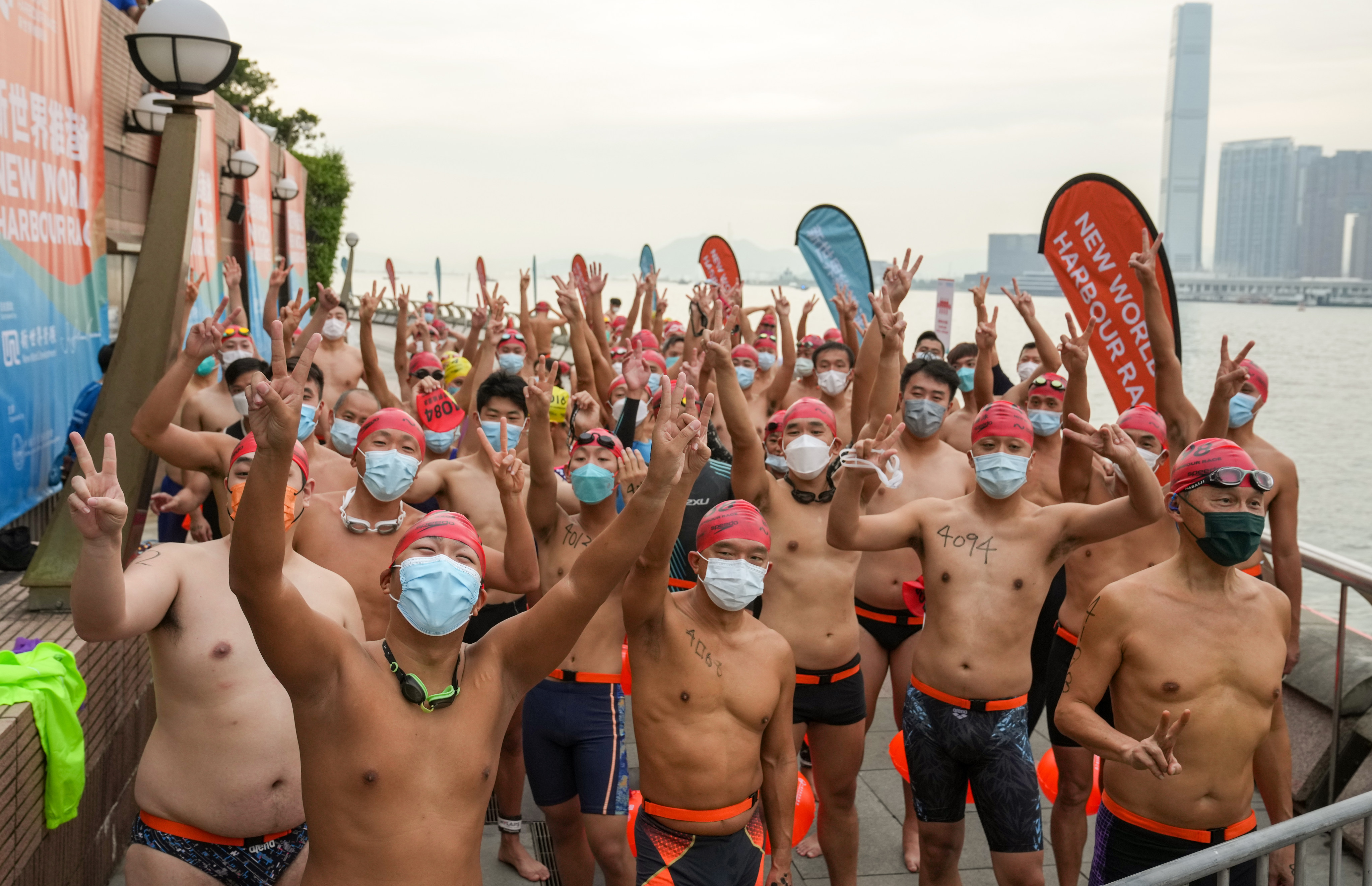 Swimmers get ready to enter the water at Golden Bauhinia Square in Wan Chai at the start of the New World Harbour Race. Photo: Sam Tsang