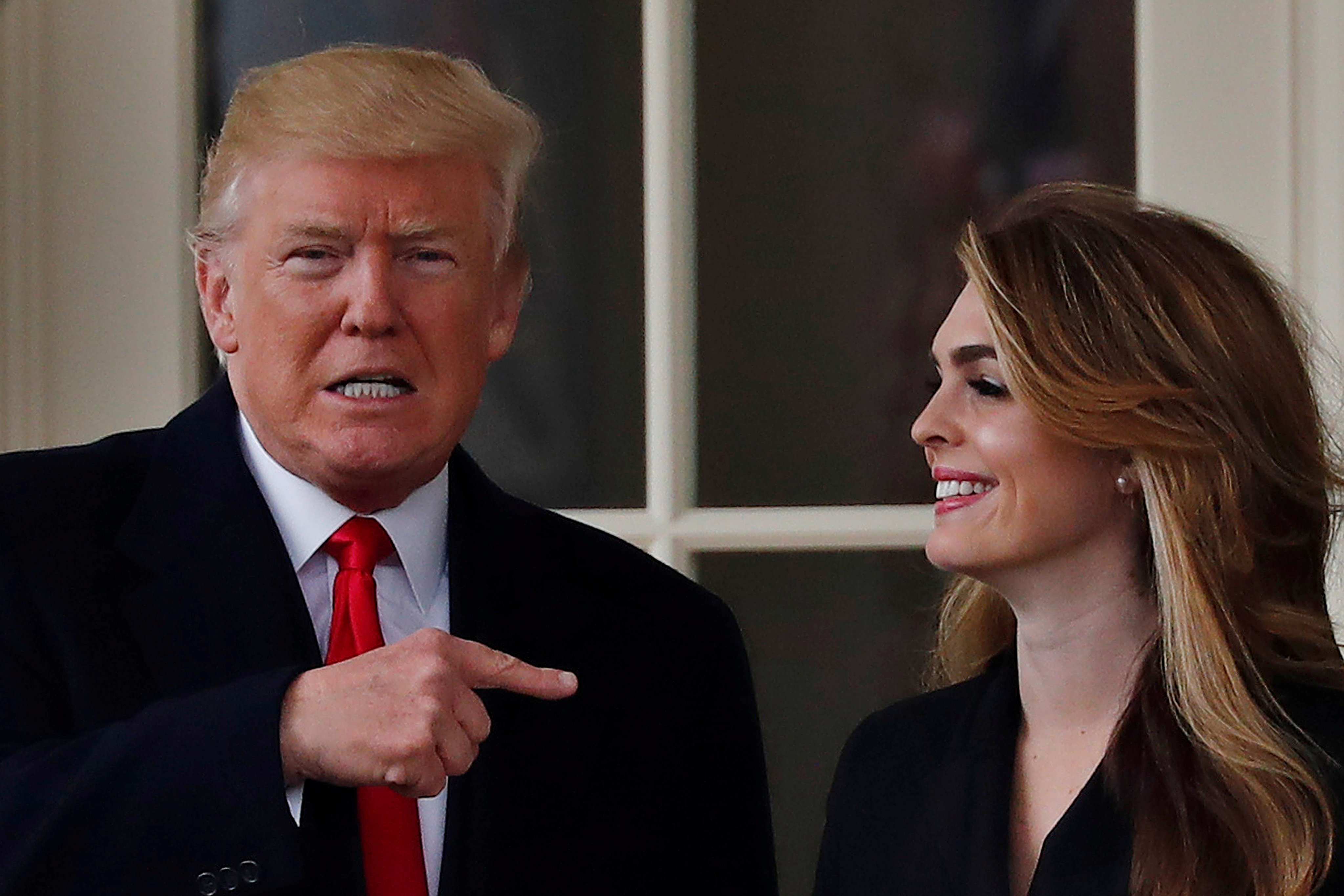 US President Donald Trump stands next to former White House communications director Hope Hicks outside the Oval Office in March 2018. Photo: Reuters