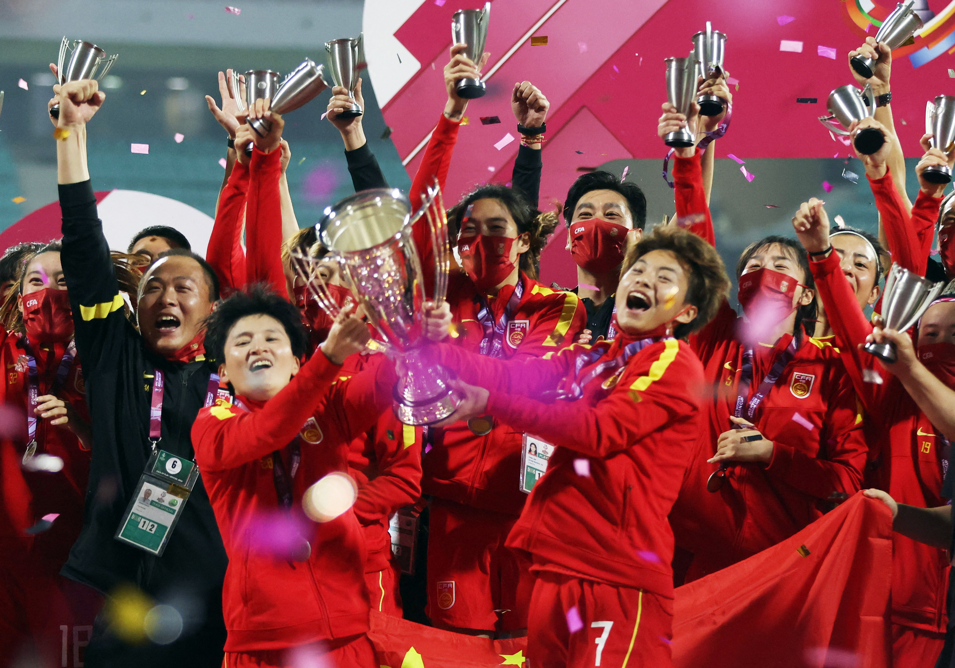 China’s Wang Shuang and Wang Shanshan hold the trophy and celebrate with their team after beating South Korea in the final of the 2022 AFC Women’s Asian Cup. Photo: Reuters