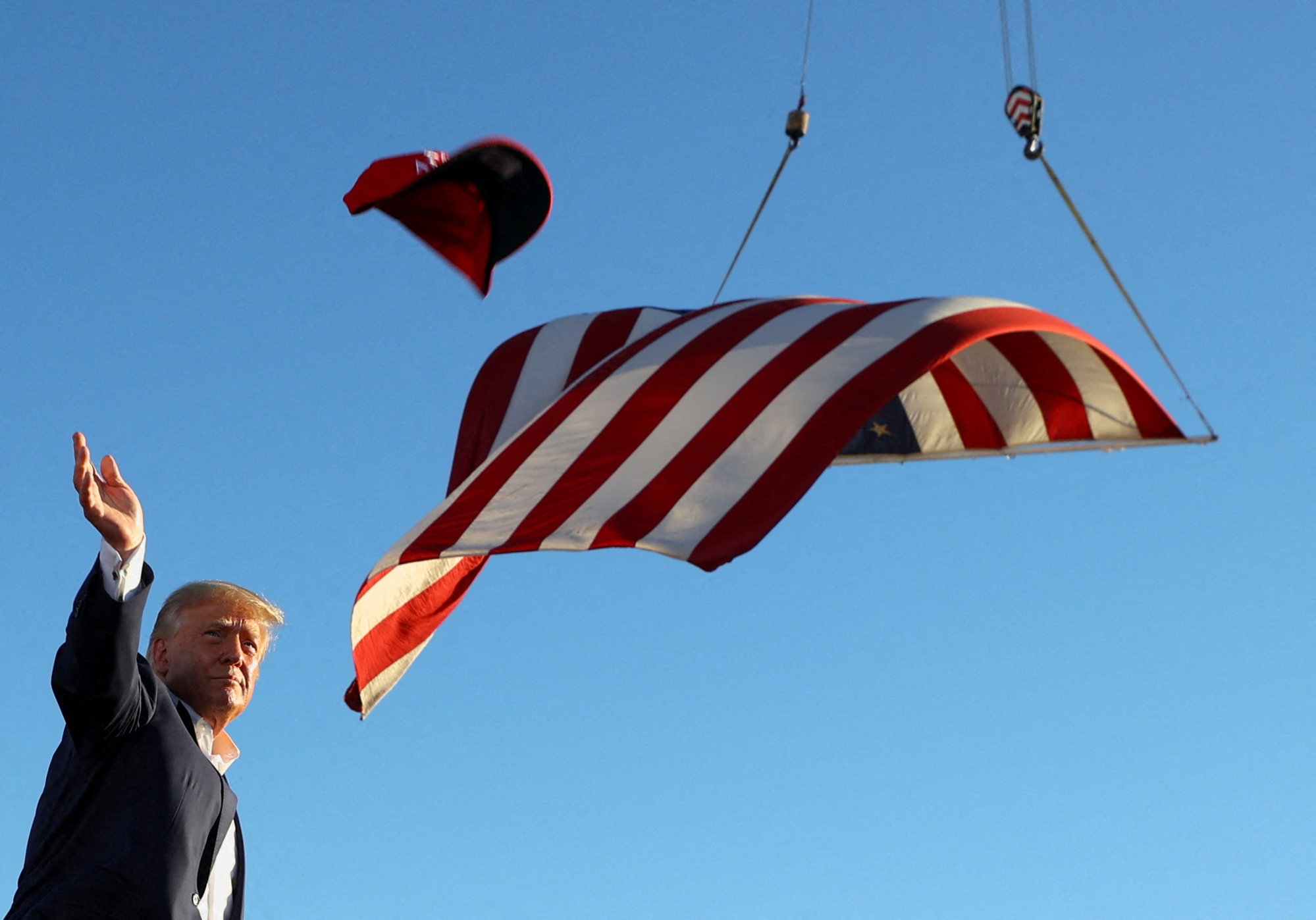 Former US president Donald Trump throws ‘Save America’ hats during a rally ahead of the midterm elections, in Mesa, Arizona. Photo: Reuters