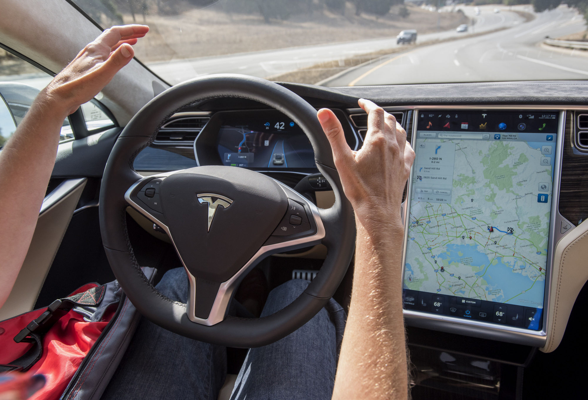 A member of the media test drives a Tesla Model S car equipped with Autopilot in Palo Alto, California, on October 14, 2015. Photo: Bloomberg