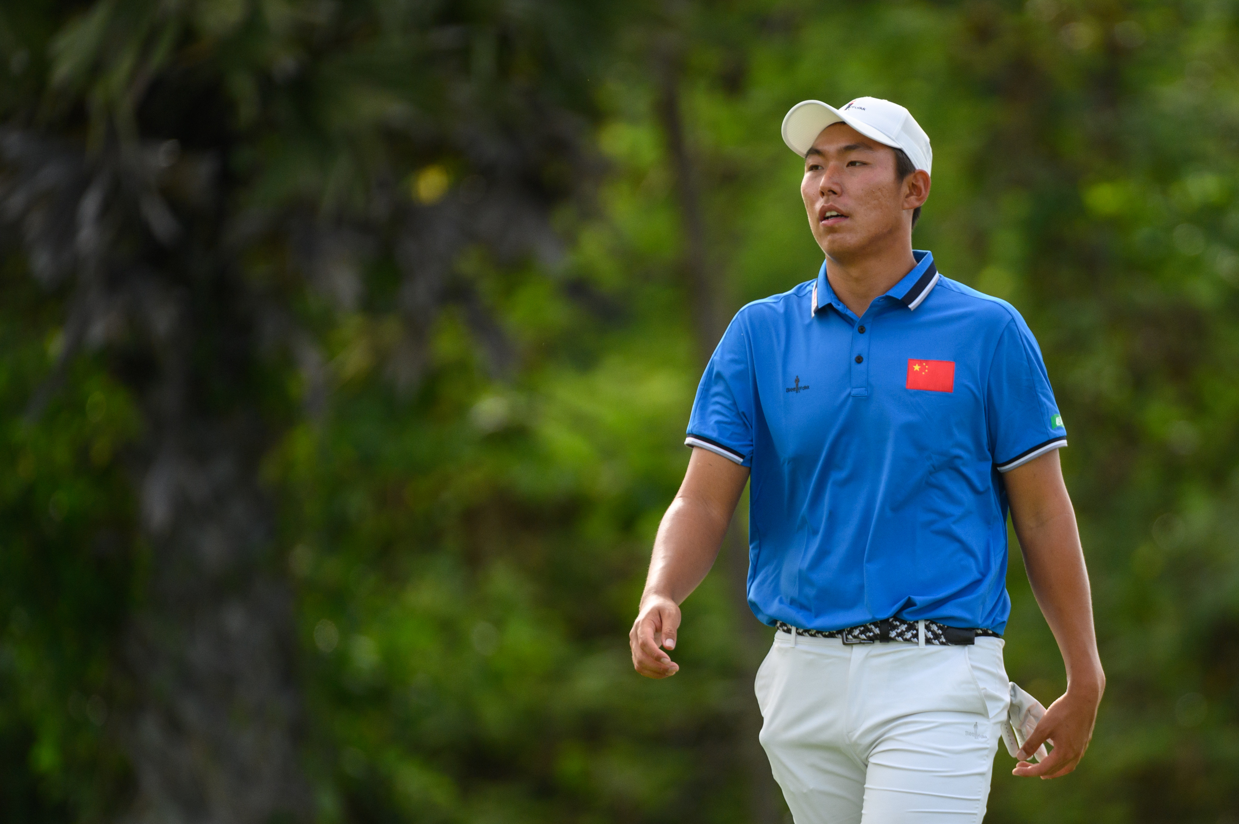 Bo Jin of China walks down the fairway in Round 1 of the 2022 Asia-Pacific Amateur Championship at the Amata Spring Country Club in Thailand. Photos: AAC
