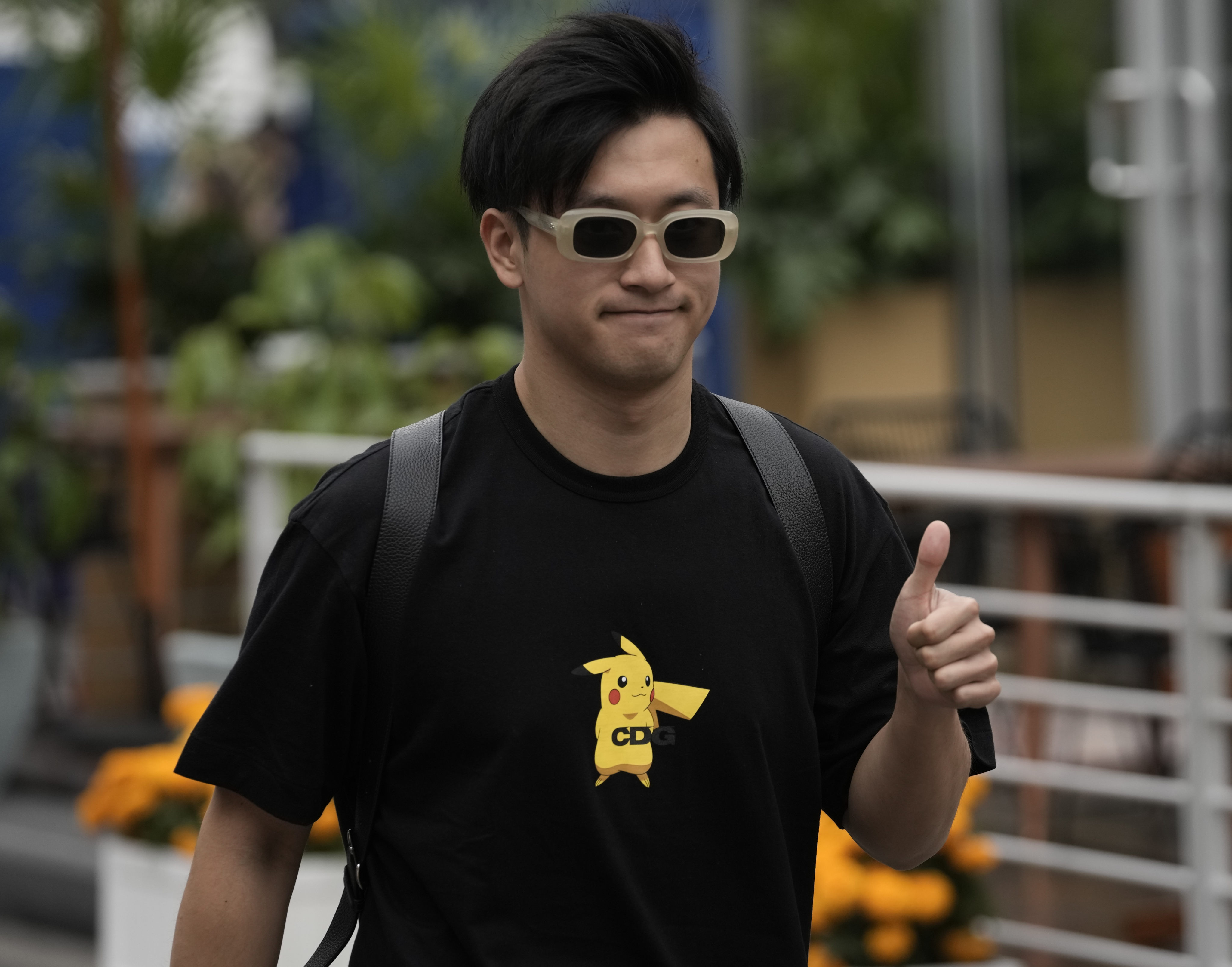 Zhou Guanyu gives a thumbs up upon his arrival for the first day of the Mexico Grand Prix. Photo: AP