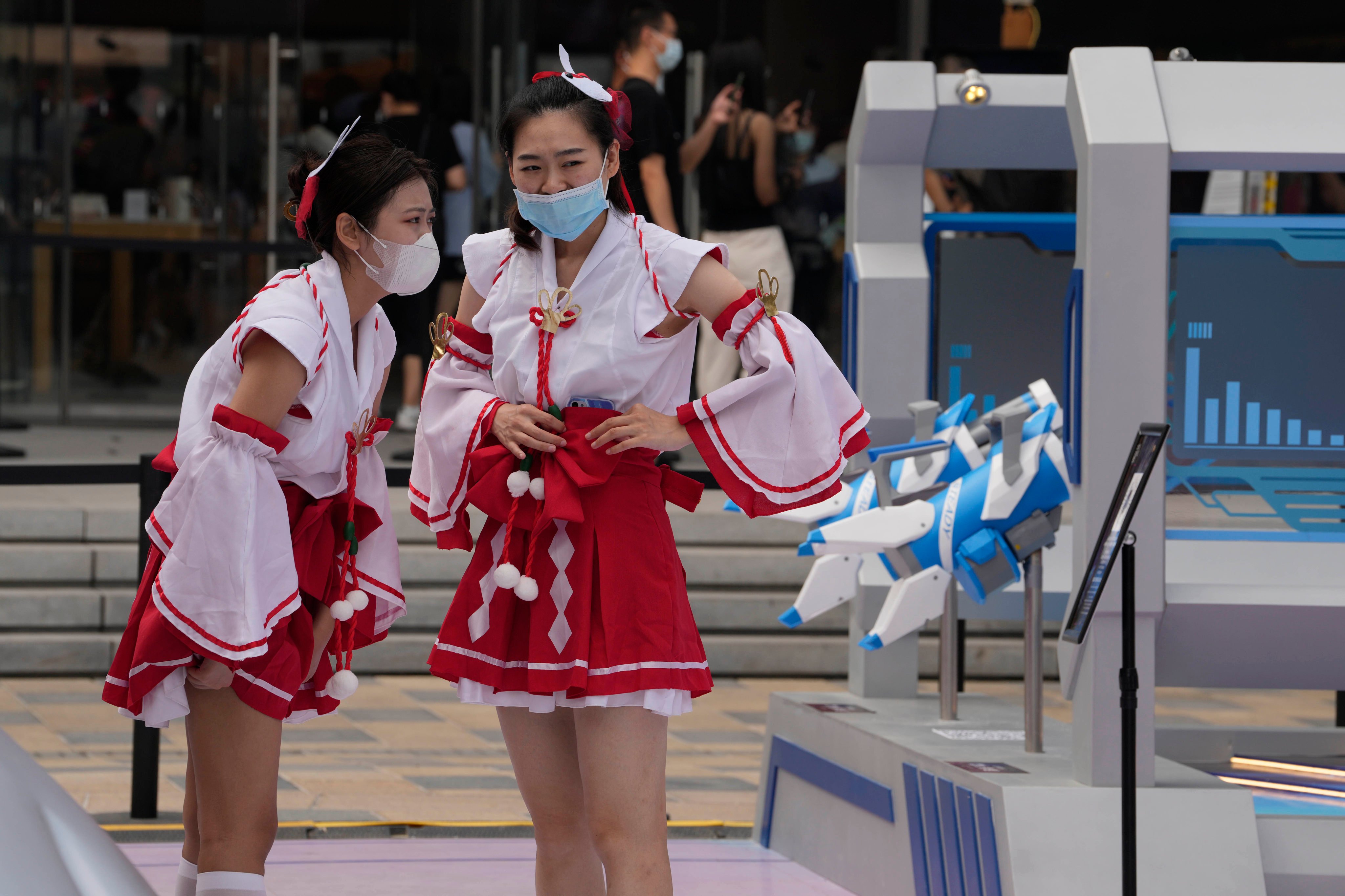 Staff are seen at a booth promoting Tencent’s popular Honor of Kings online game in Beijing. Photo: AP Photo