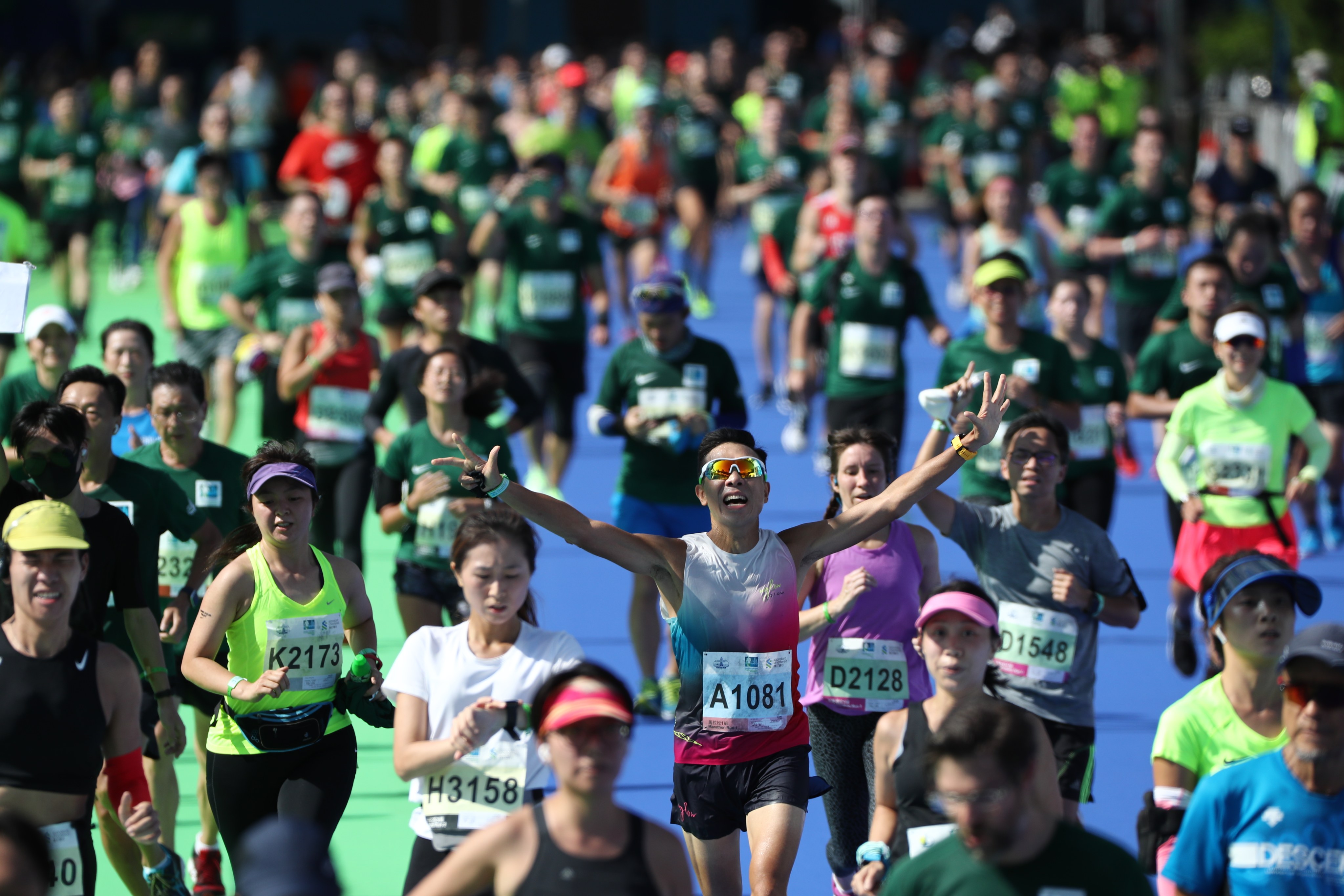 Runners arrive at the 2021 Standard Chartered Hong Kong Marathon finish line at Victoria Park. Photo: Nora Tam