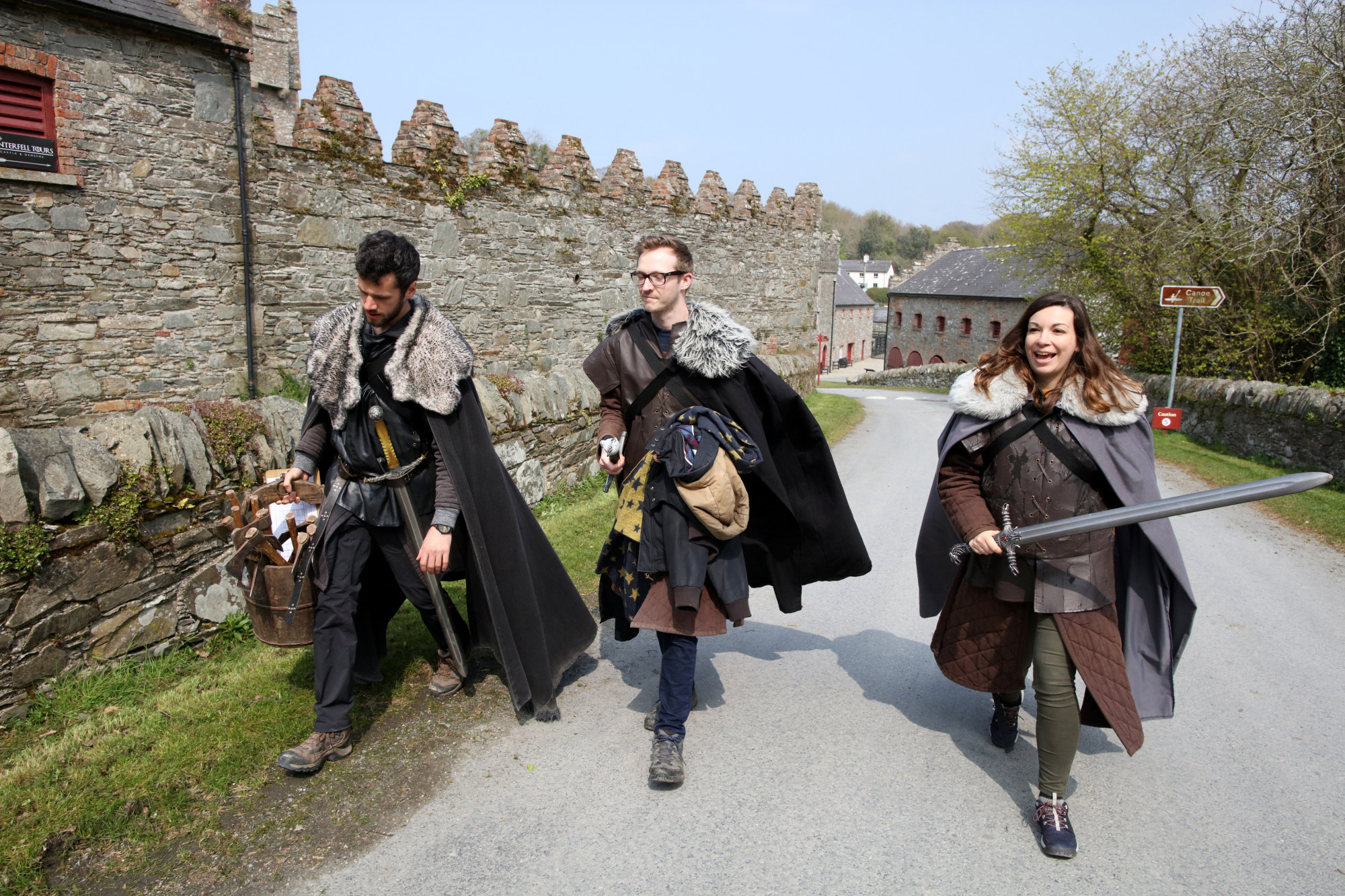 British Game of Thrones fans Declan Blakey (centre) and Katherine Hibberd (right) and French fan Hugo Chivard (left) take part in the tourist experience at the Castle Ward Estate in Strangford, Northern Ireland, in April 2019, the location of Winterfell in Game of Thrones, and one of the many locations used by the hit HBO show across the province. Photo: AFP