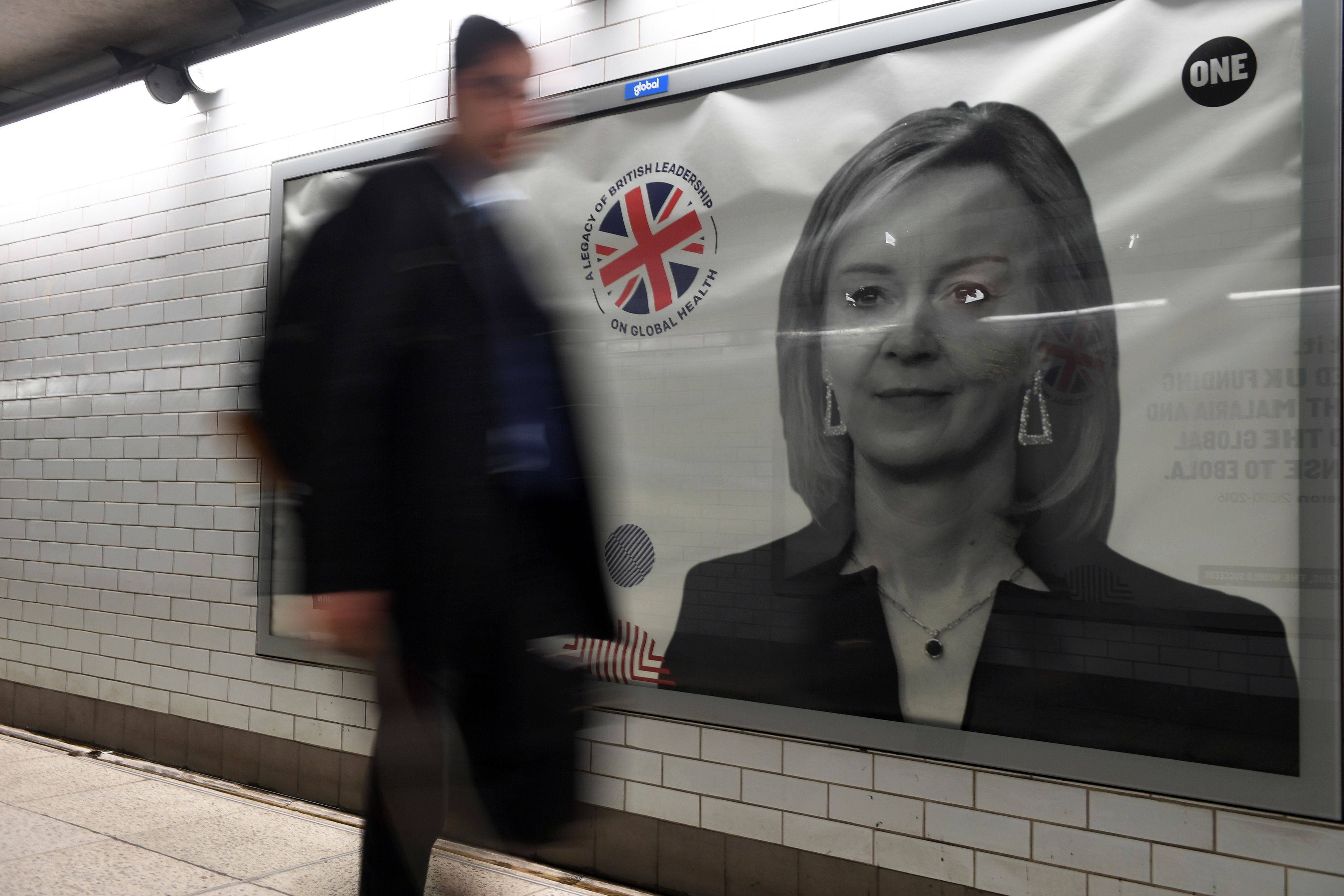 A pedestrian passes a billboard advertisement for Liz Truss, outgoing UK prime minister, on a public walkway in London. Photo: Bloomberg