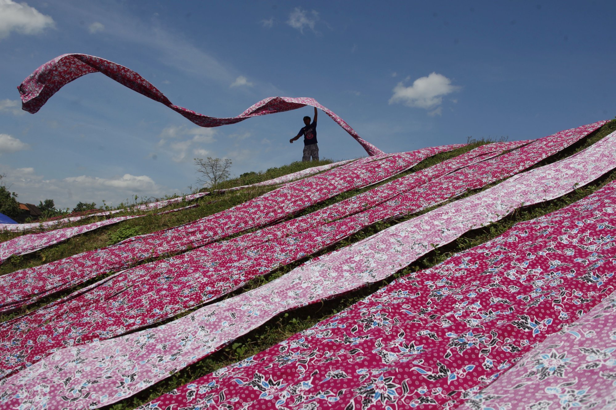 An employee throws batik fabric in an industrial area in Sukoharjo, Central Java province, Indonesia in July 2021. Photo: Antara Foto via Reuters